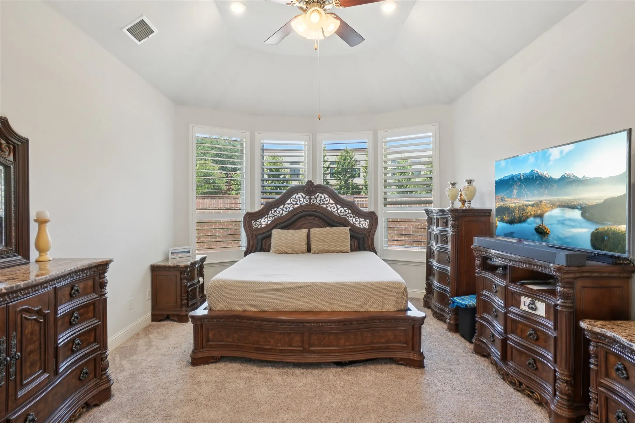 Bedroom with light carpet and ceiling fan