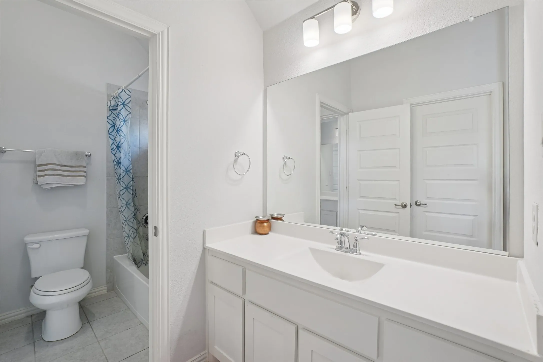 Full bath featuring vanity, tile patterned flooring, and shower / bath combo