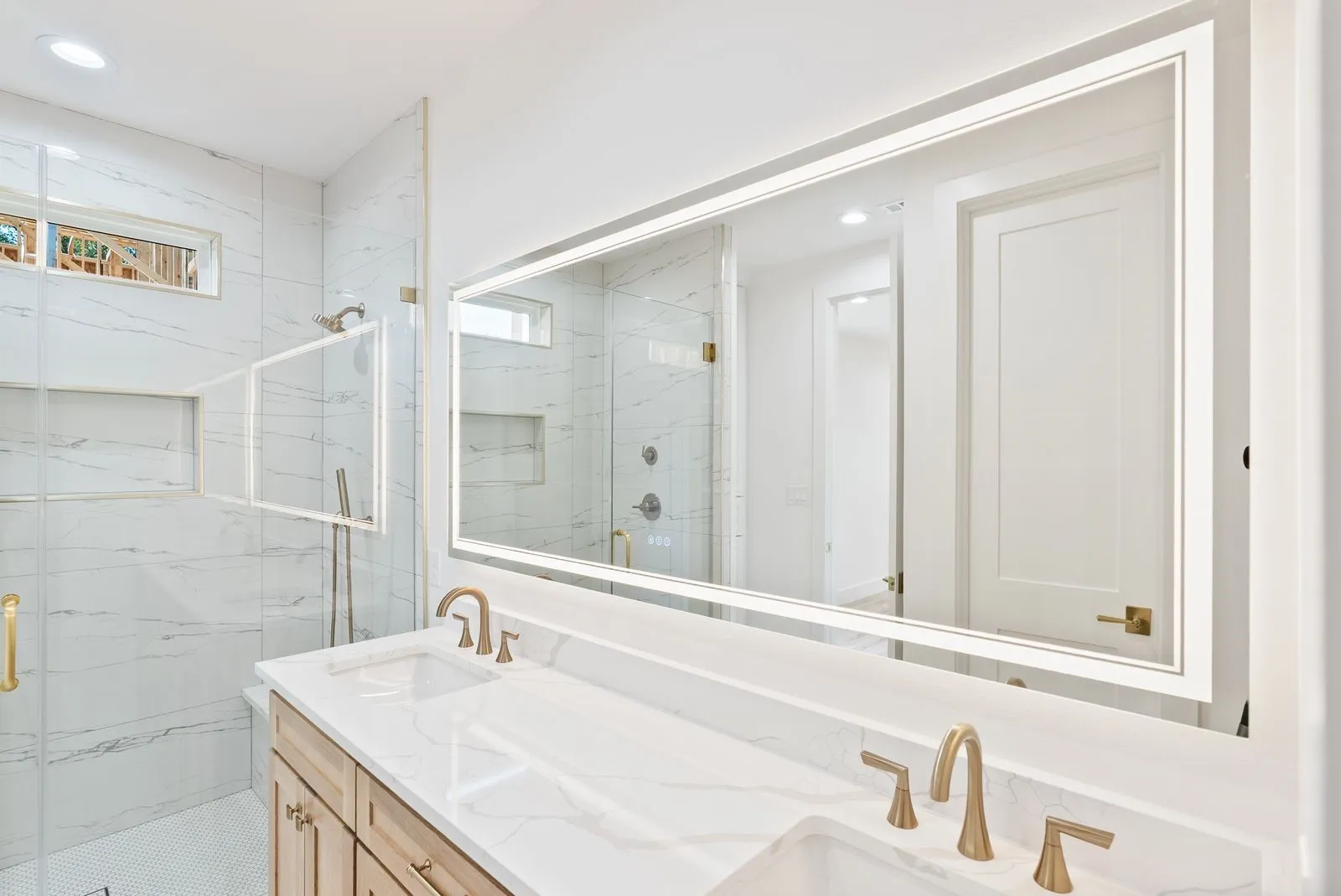 Double vanity with undermount sinks and brushed gold fixtures
