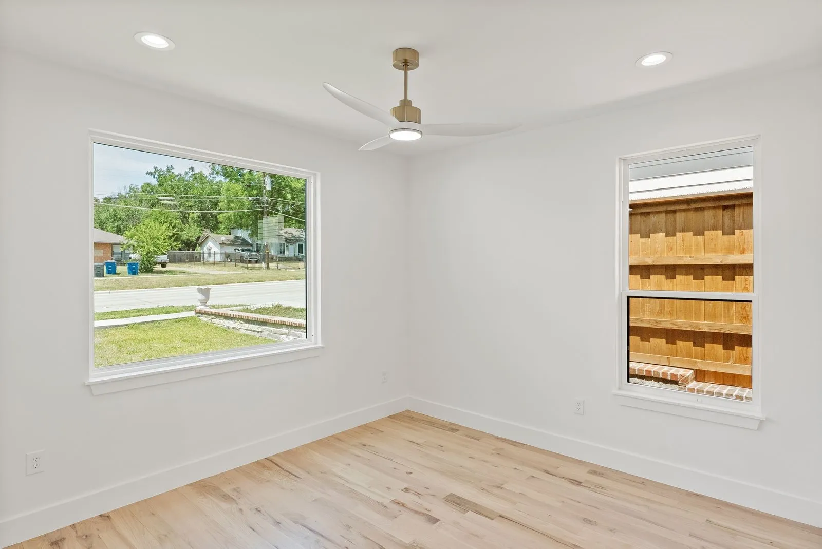 Recessed lighting, light wood-finish flooring, white walls, and a contemporary ceiling fan