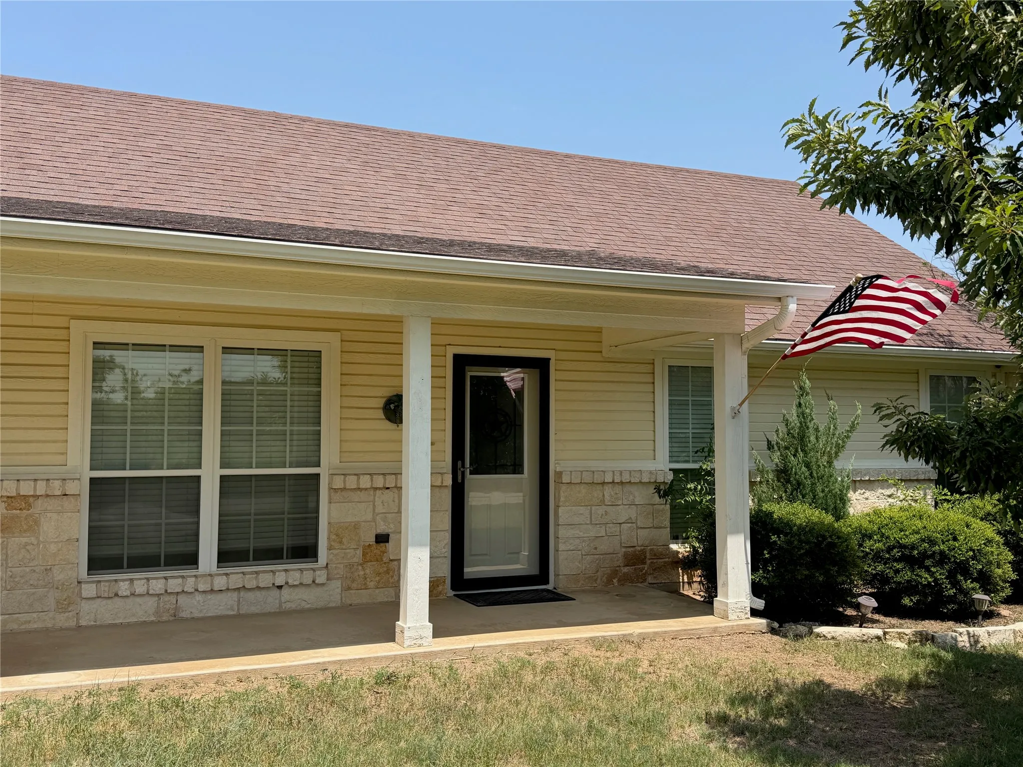 Covered entry with stone facade and hardie siding