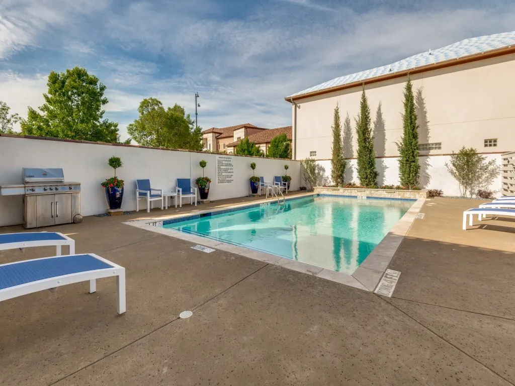Resort-Style Pool Oasis with Sparkling Saltwater Pool, Integrated Spa Lounging Area, and Expansive Concrete Decking