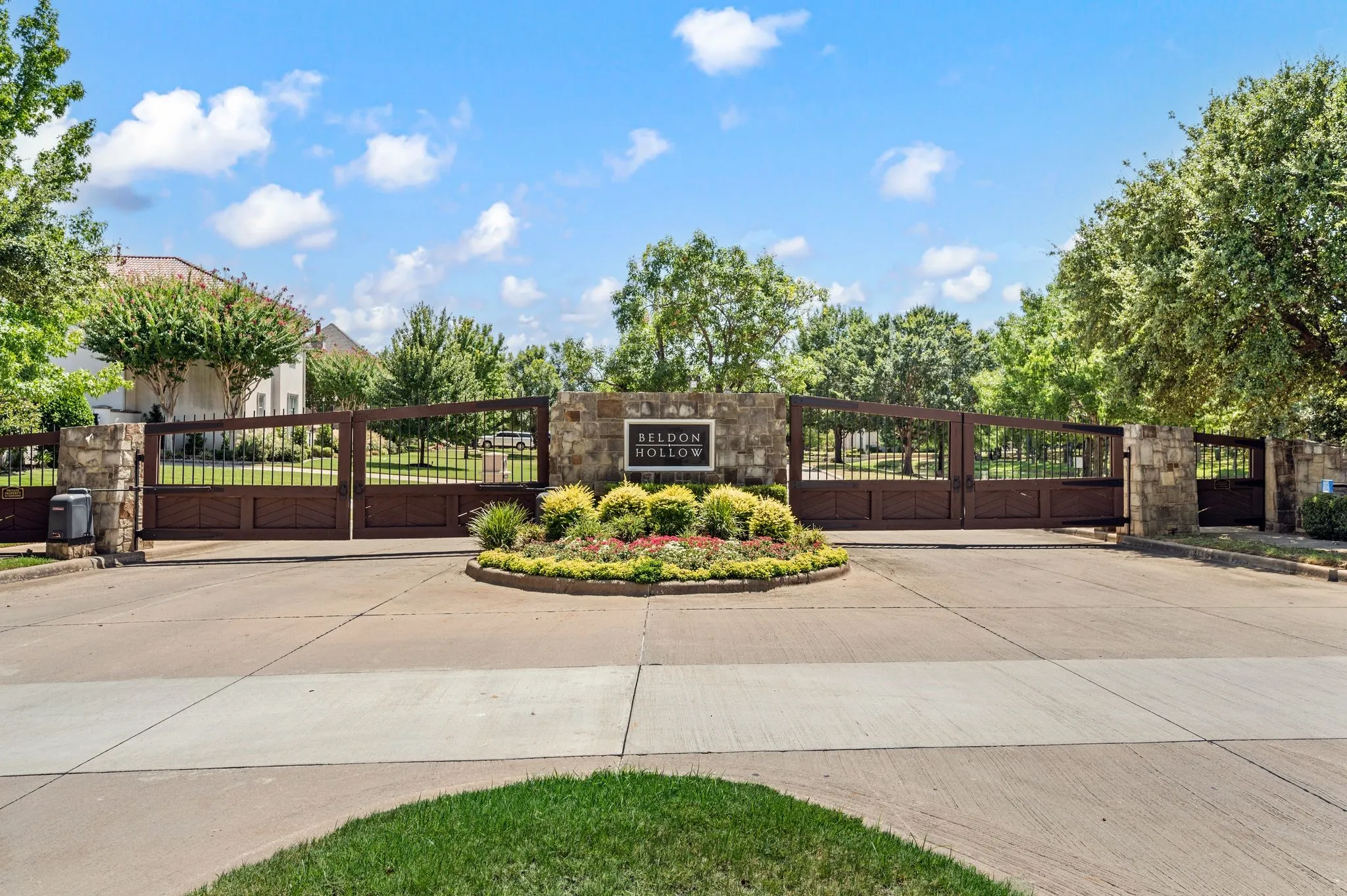 Gated Entry to the Prestigious Beldon Hollow with manicured grounds, mature landscaping, and a private waterfront setting