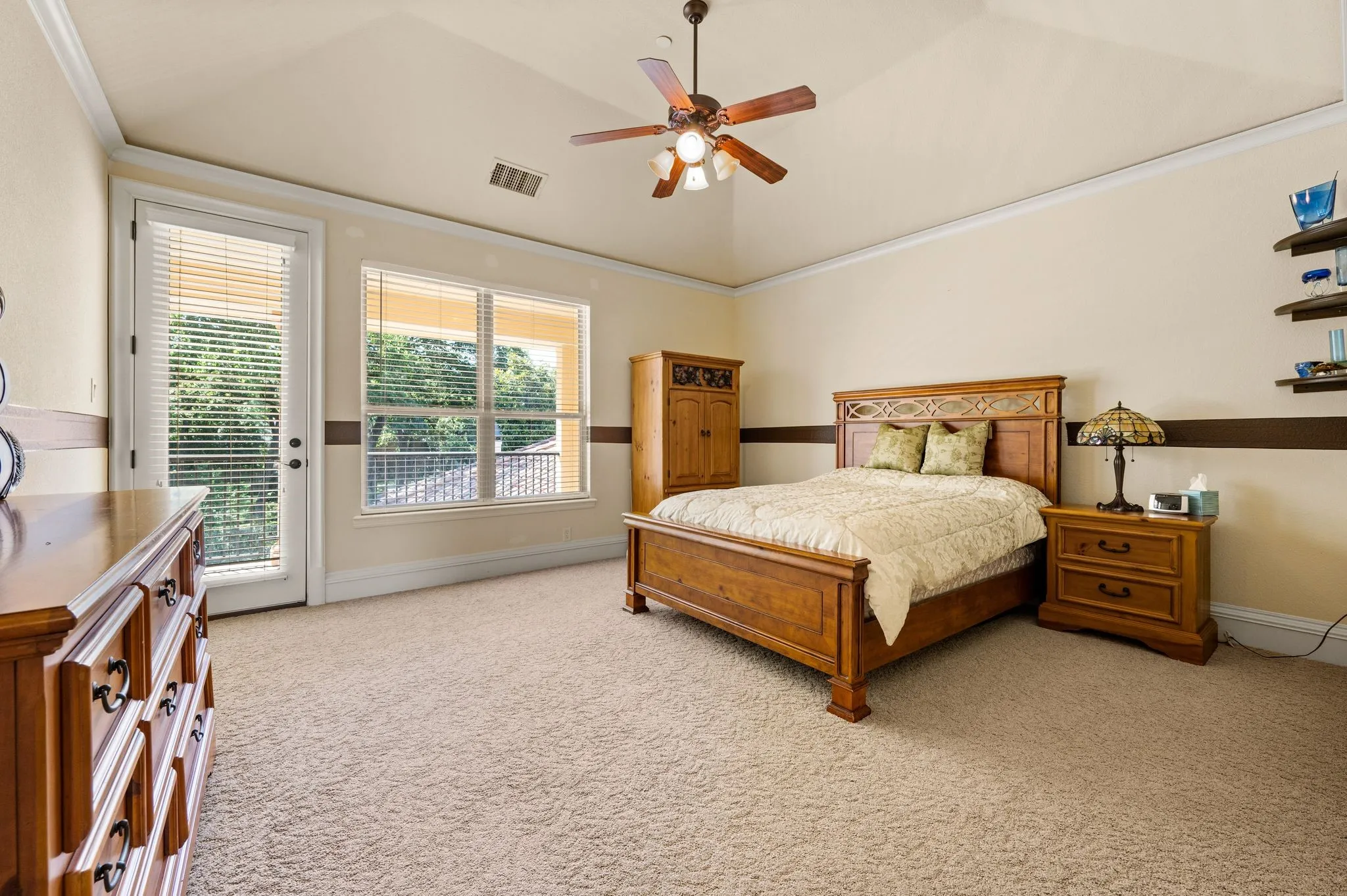 Vaulted ceiling with crown molding, ceiling fan, and recessed lighting