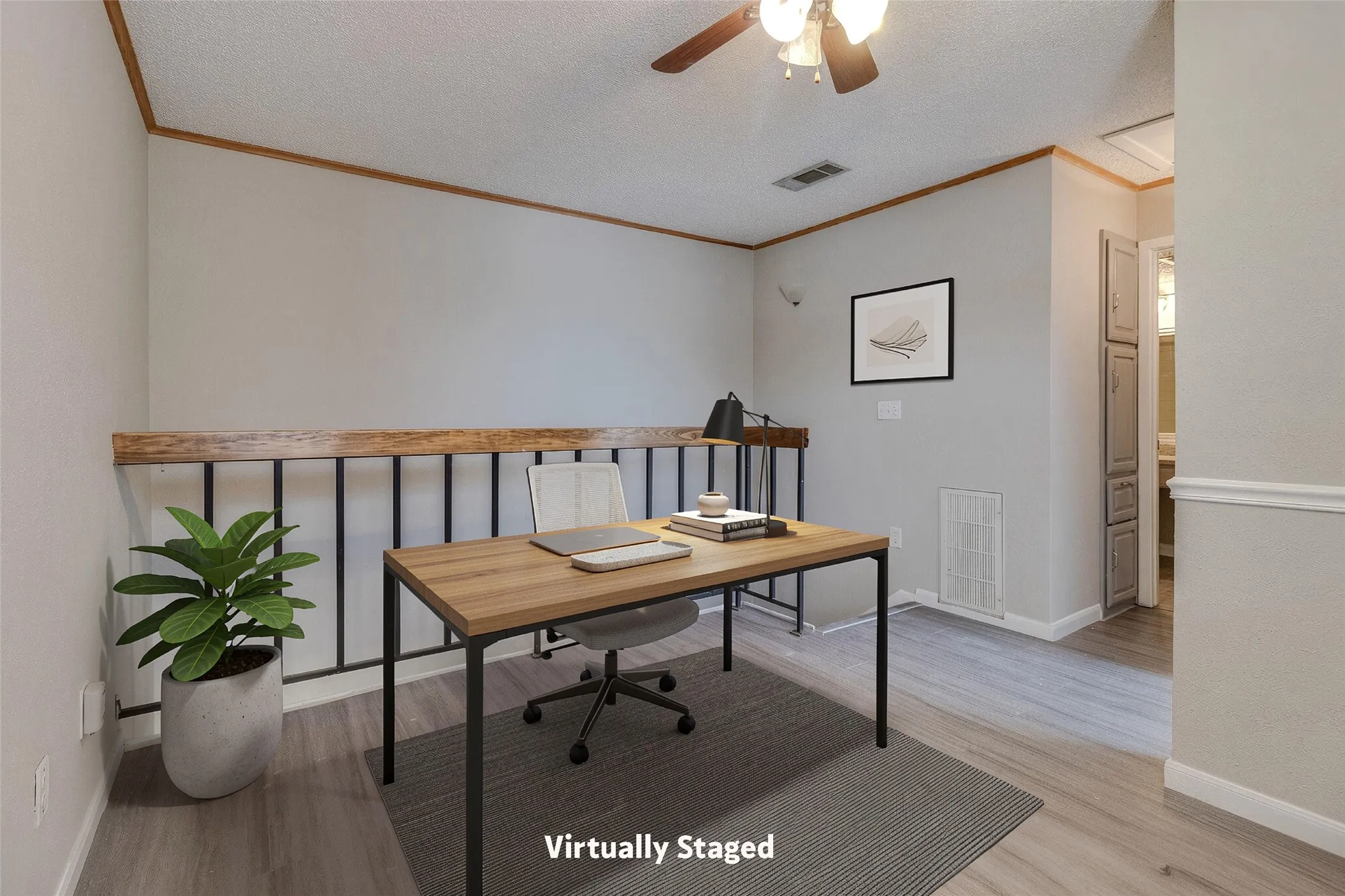 Loft space featuring wood-finish flooring, wood trim, an open railing, and ceiling fan