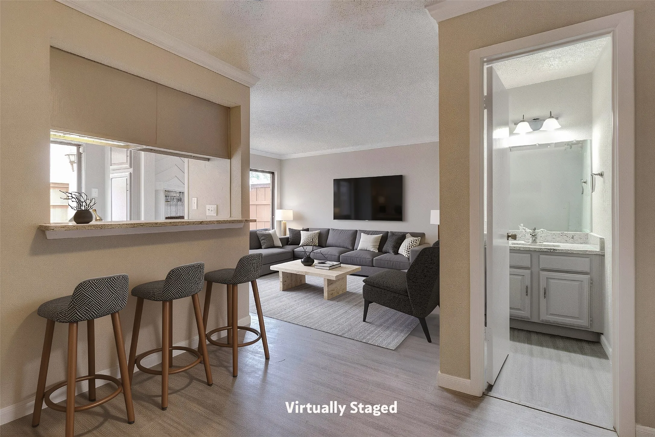 Open concept living area with wood-finish flooring, a breakfast bar, and crown molding