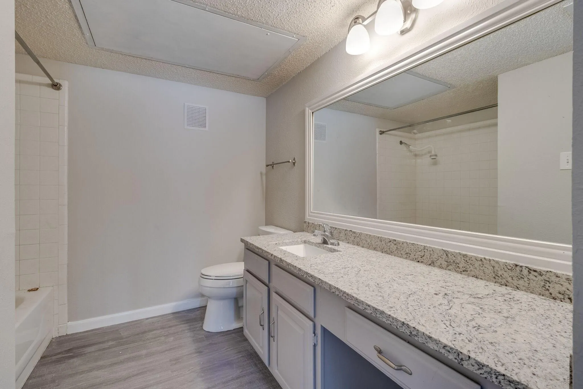 Luxury vinyl flooring with a full bathtub/shower combination