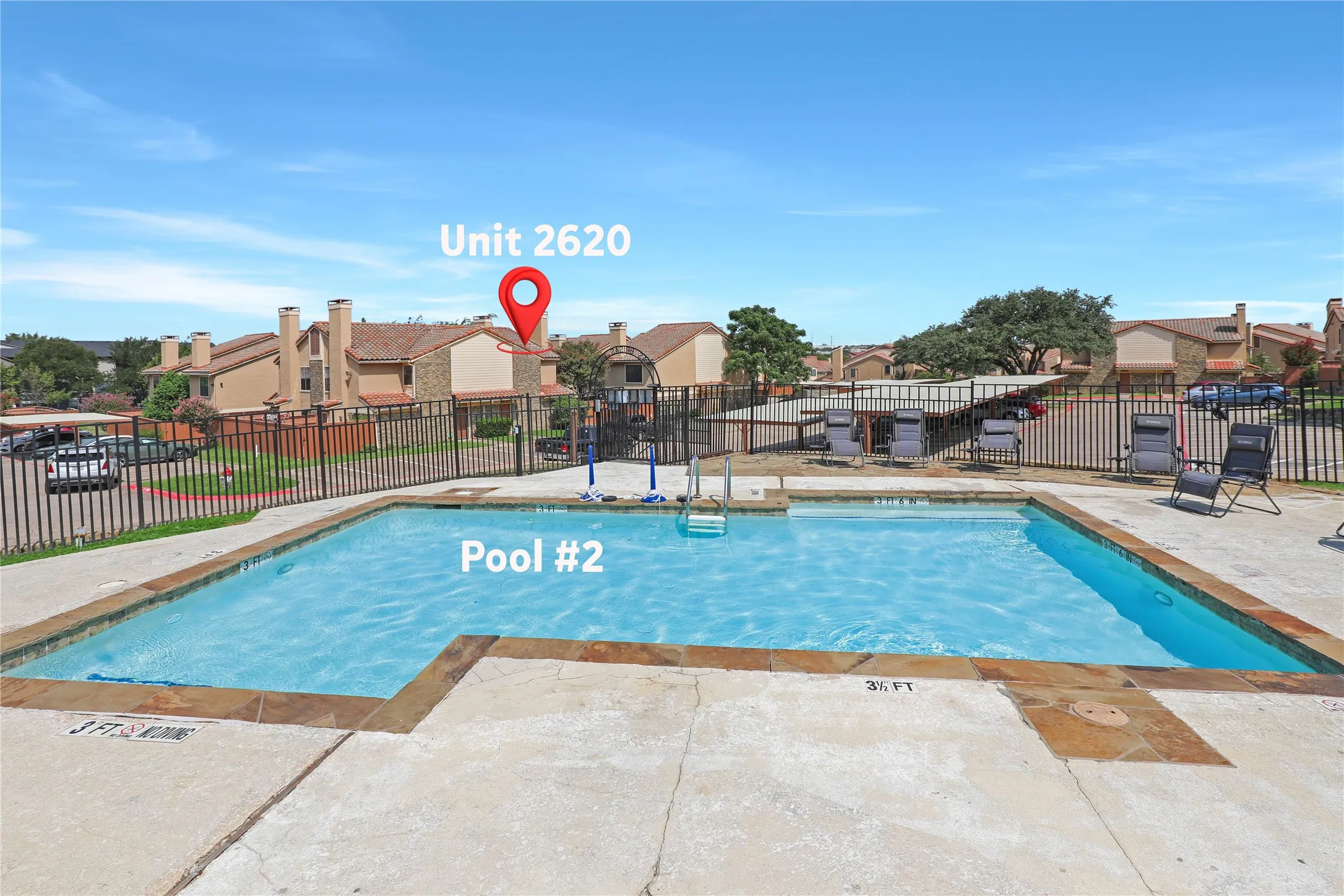 Community swimming pool featuring a stone-coping edge and surrounding concrete deck