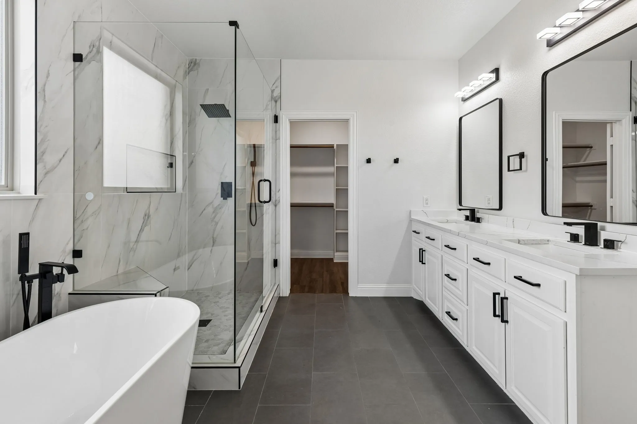Dual vanity with white cabinetry and black hardware