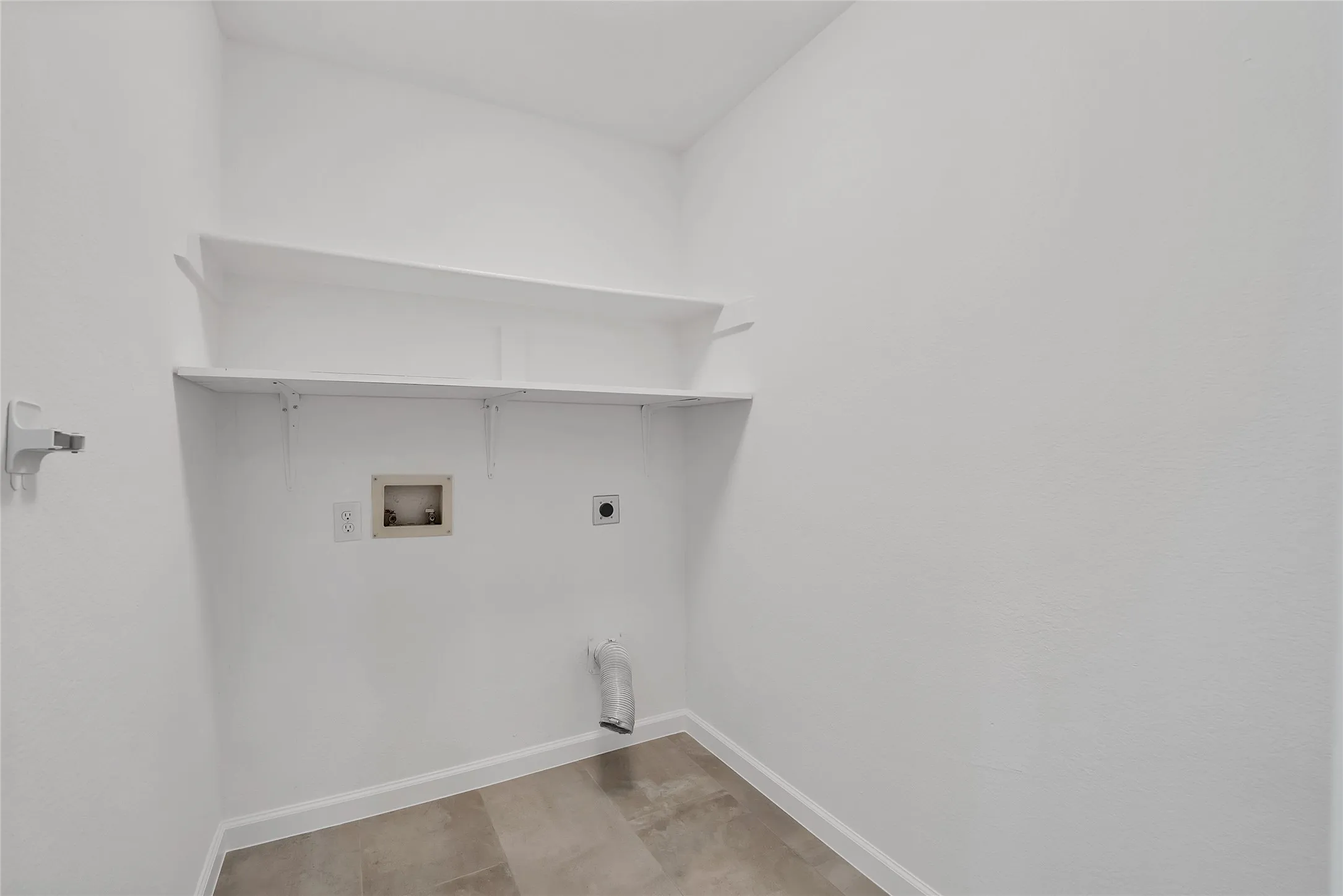 Utility room has convenient shelves for your detergent and additional storage.