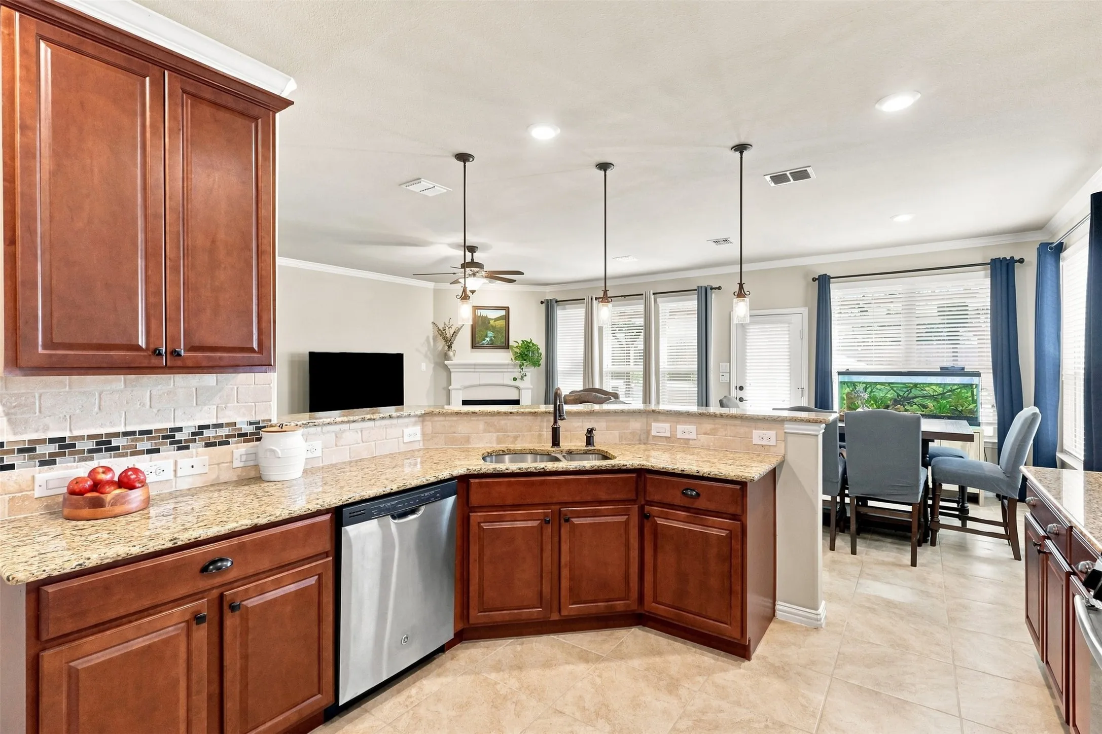 Open Gourmet kitchen featuring Decorative Tile Backsplash and Pendant Lighting.