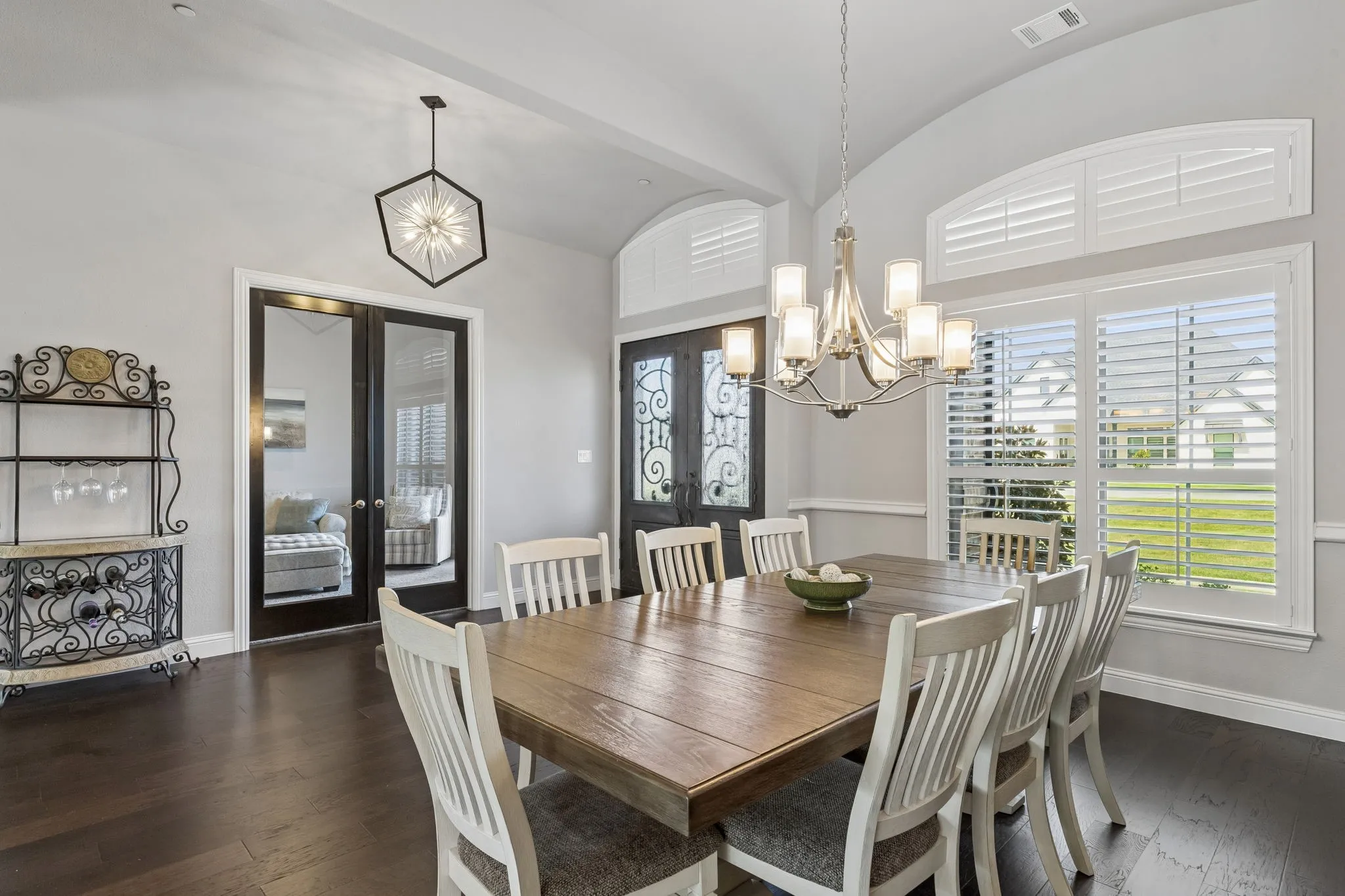 Dining to Entry with Modern Lighting and Iron Front Doors