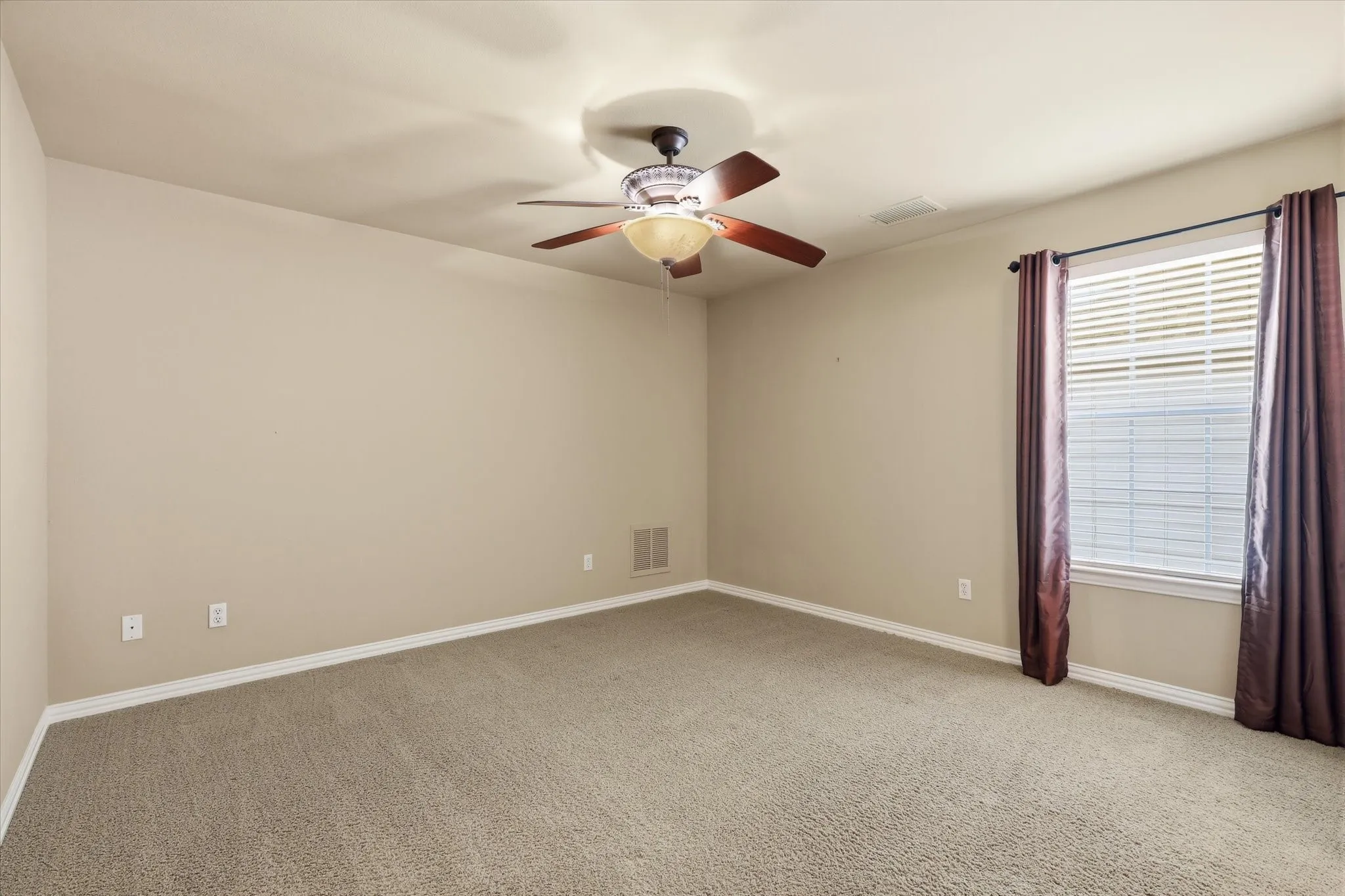 Upstairs bedroom with neutral finishes and abundant natural light.