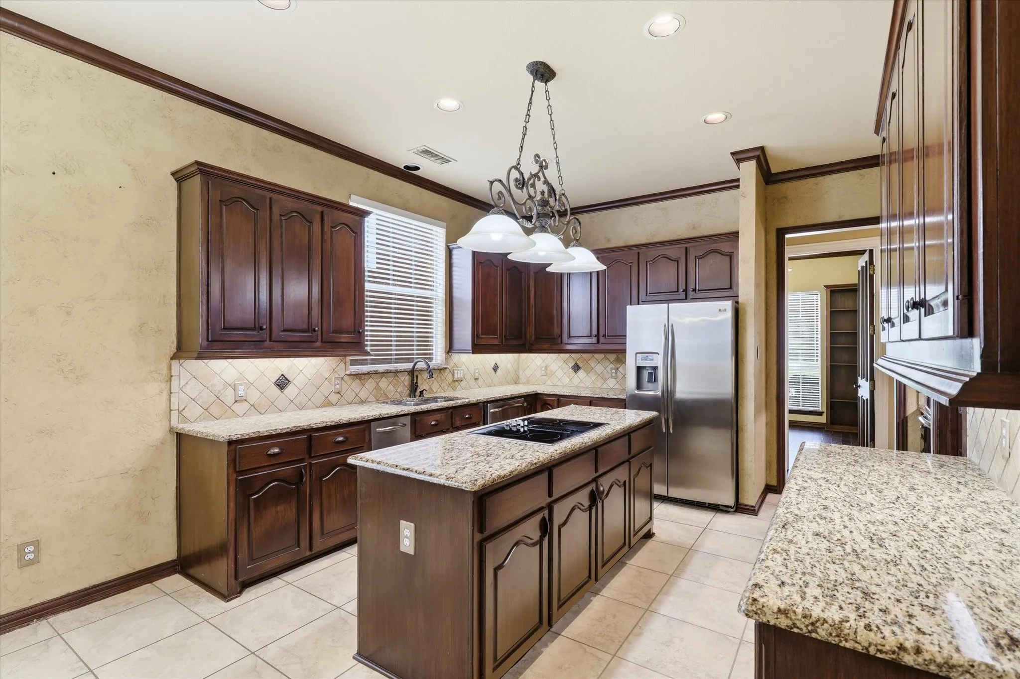 Rich wood cabinetry, granite countertops and quality appliances make this kitchen both attractive and practical.