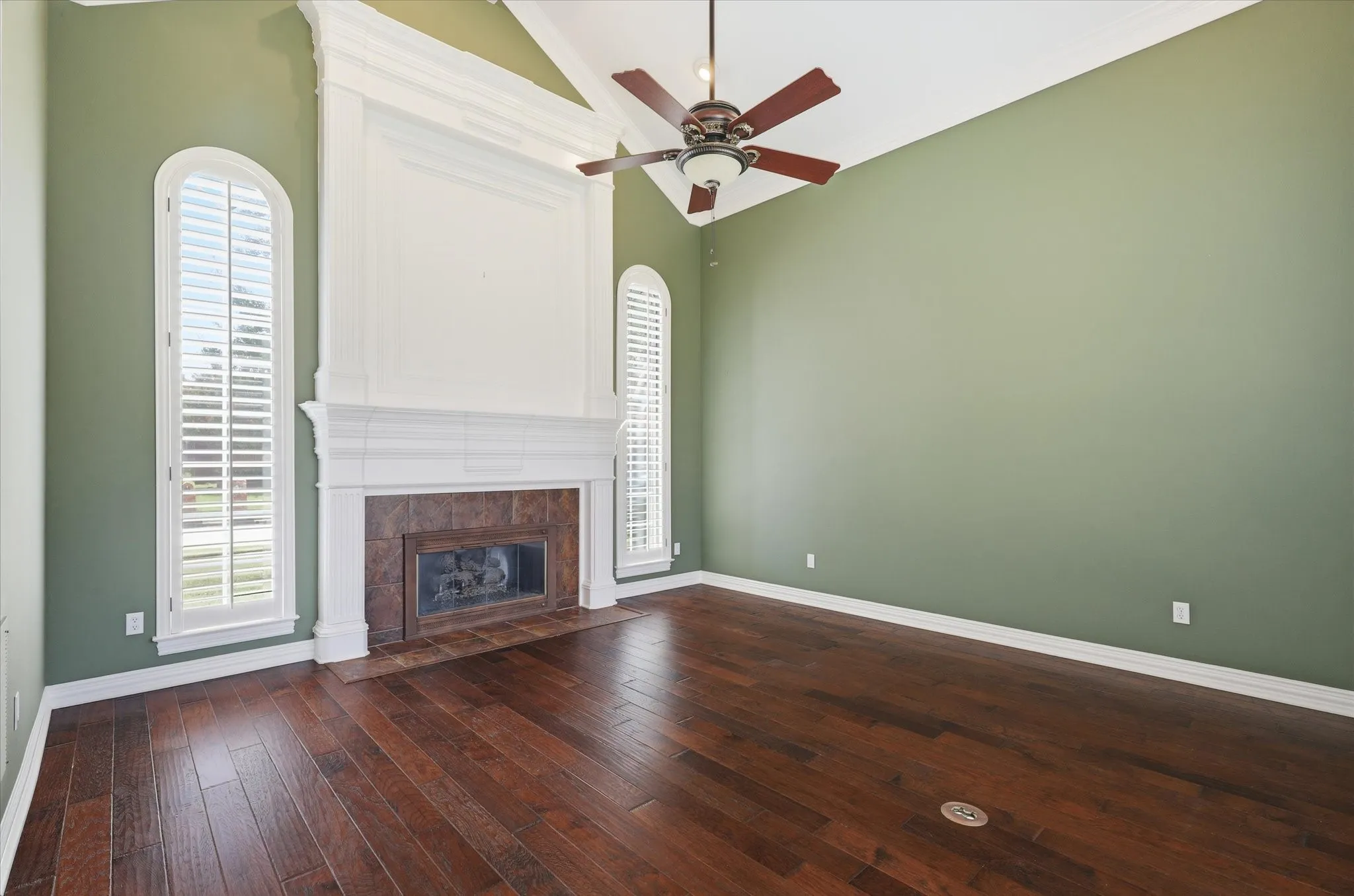 The formal living room offers soaring ceilings, hardwood floors and abundant natural light, creating an elegant space to welcome guests.