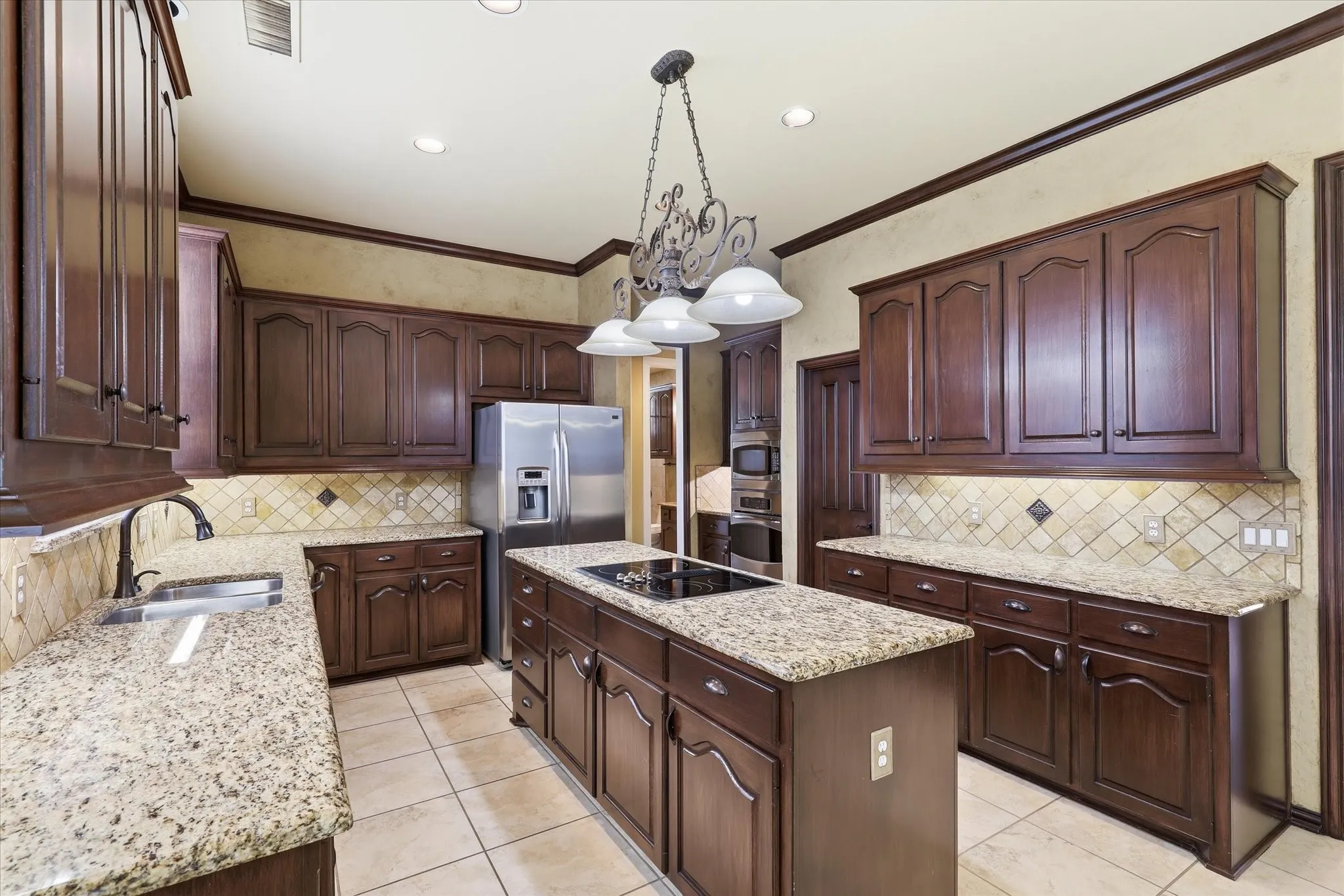 Another kitchen view highlighting the extensive cabinetry and prep space. Enormous walk in pantry is to the right of the ovens is large enough for all your cooking and storage needs.