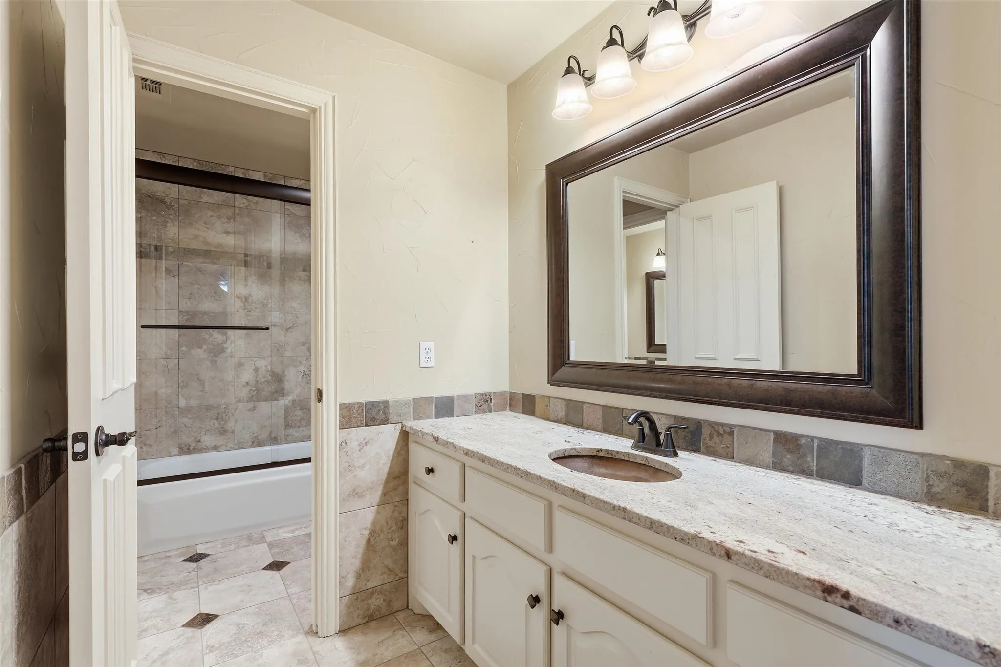 Secondary bathroom with ample vanity space and quality finishes.  Each room upstairs has its own spacious vanity space with shared tub/shower.