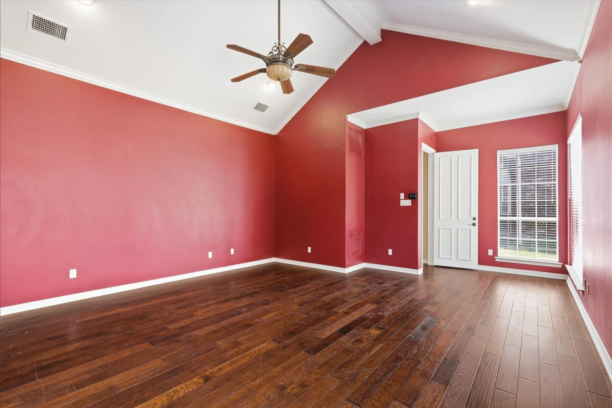 The primary bedroom features large windows , high ceilings and ample wall space for flexible furniture placement all located in a separated space from the remaining bedrooms.