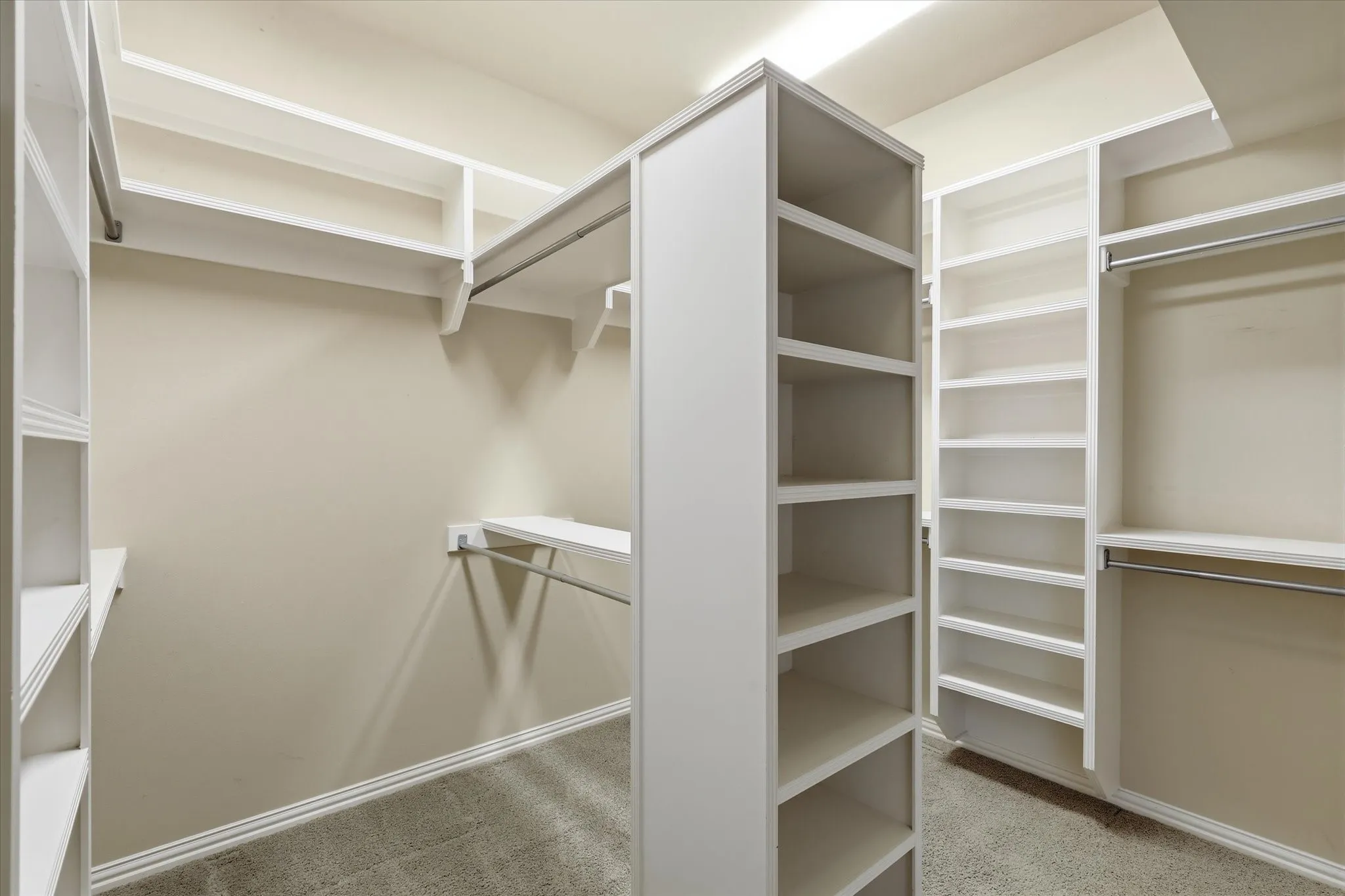 The oversized walk-in closet features extensive built-in shelving and exceptional storage.