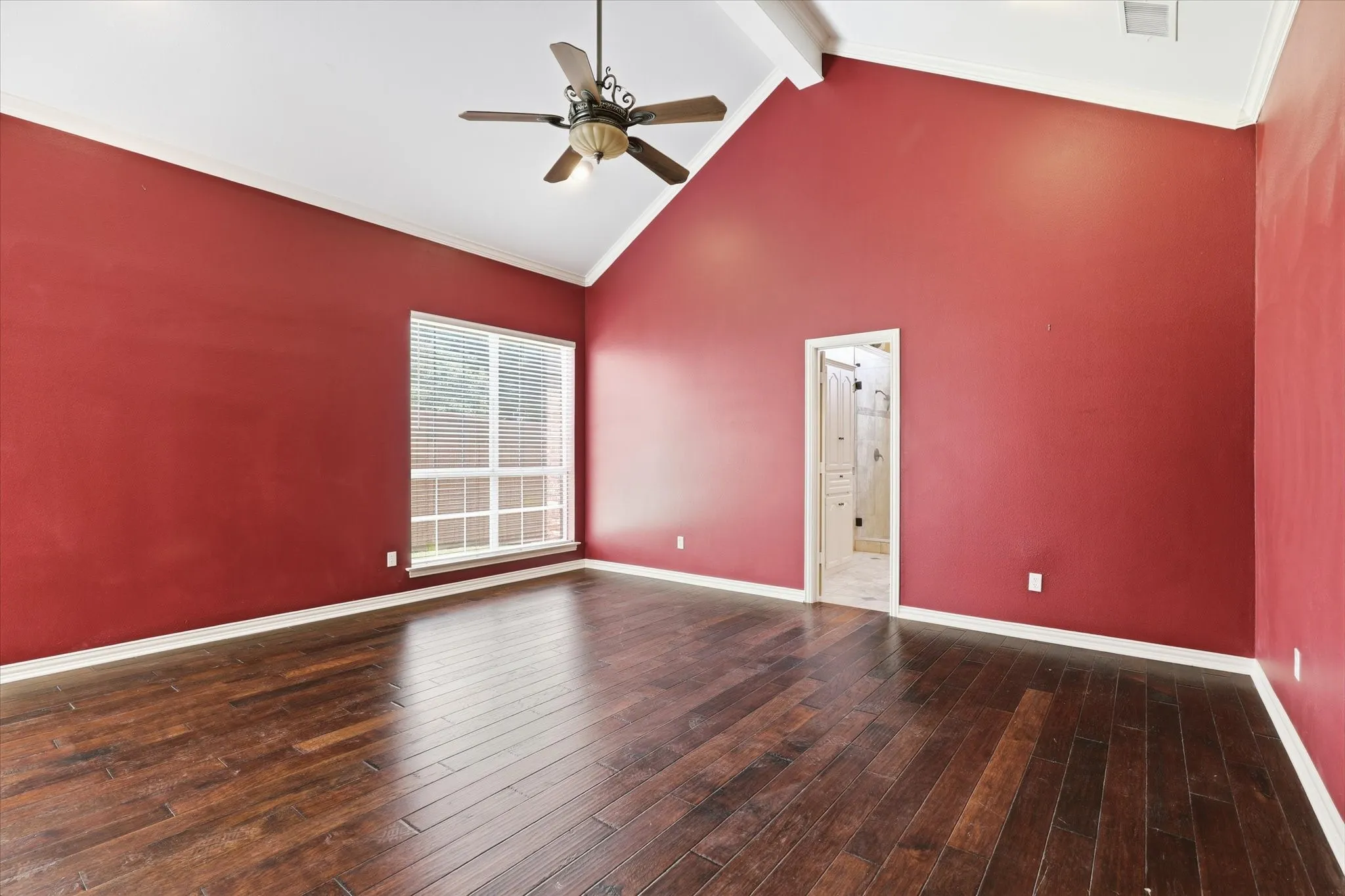 Another view of the primary bedroom showcasing its generous proportions.