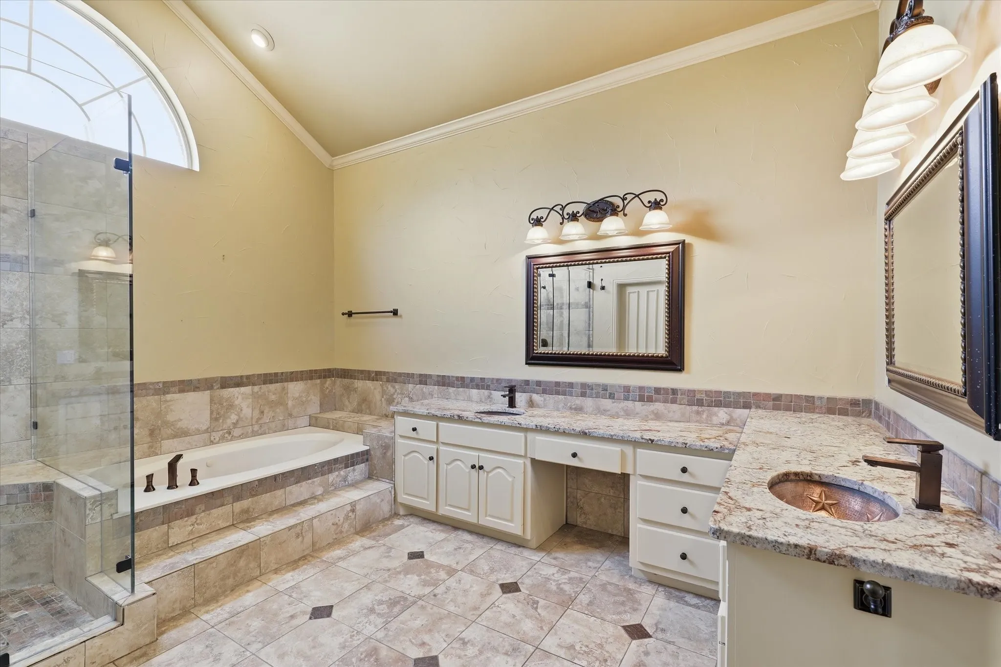 The spacious primary bath offers dual vanities, abundant counter space and quality finishes.