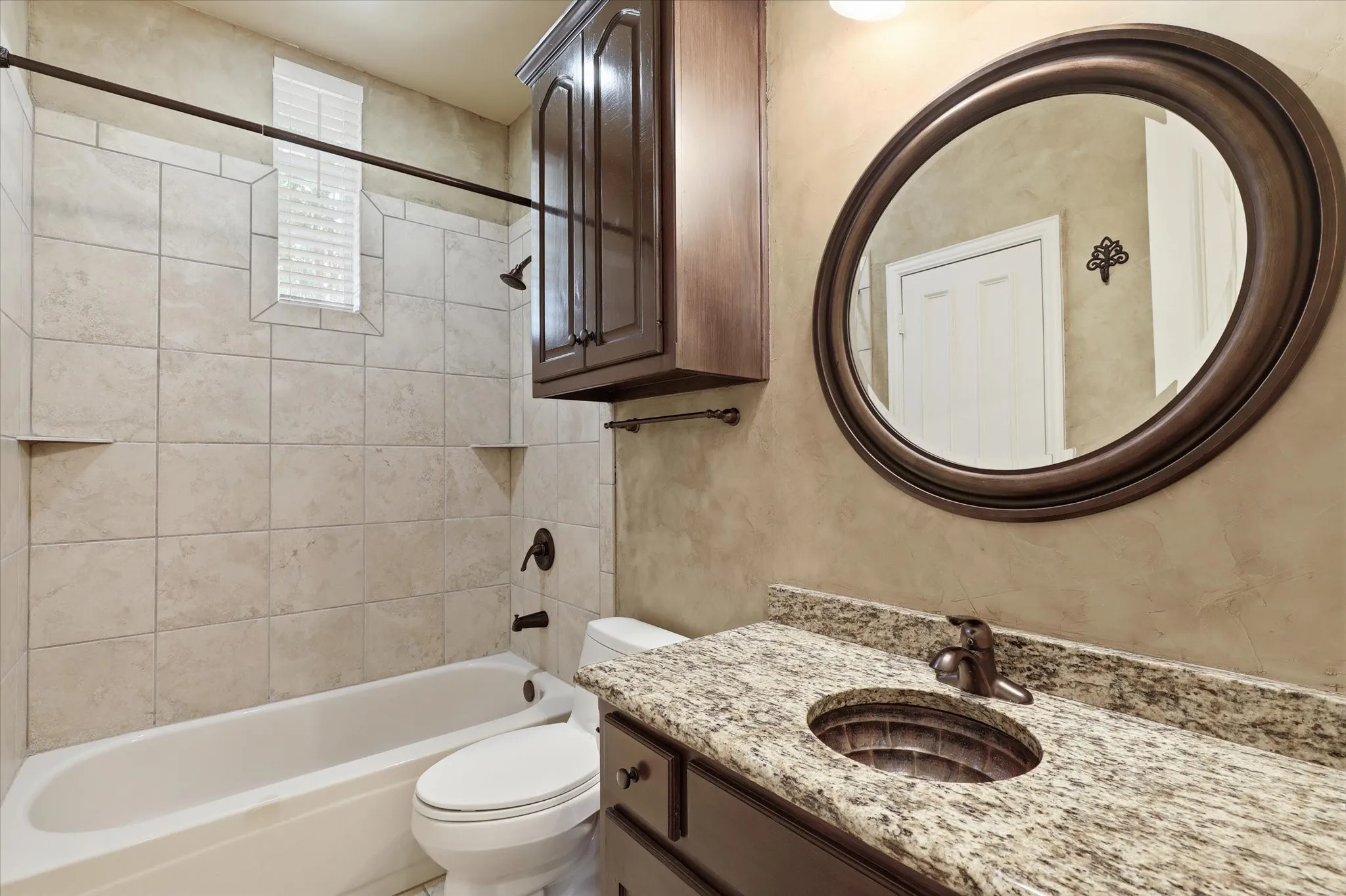 Secondary bathroom featuring updated fixtures and a clean, functional design can be accessed from the secondary bedroom or the hallway near the kitchen and formal spaces.