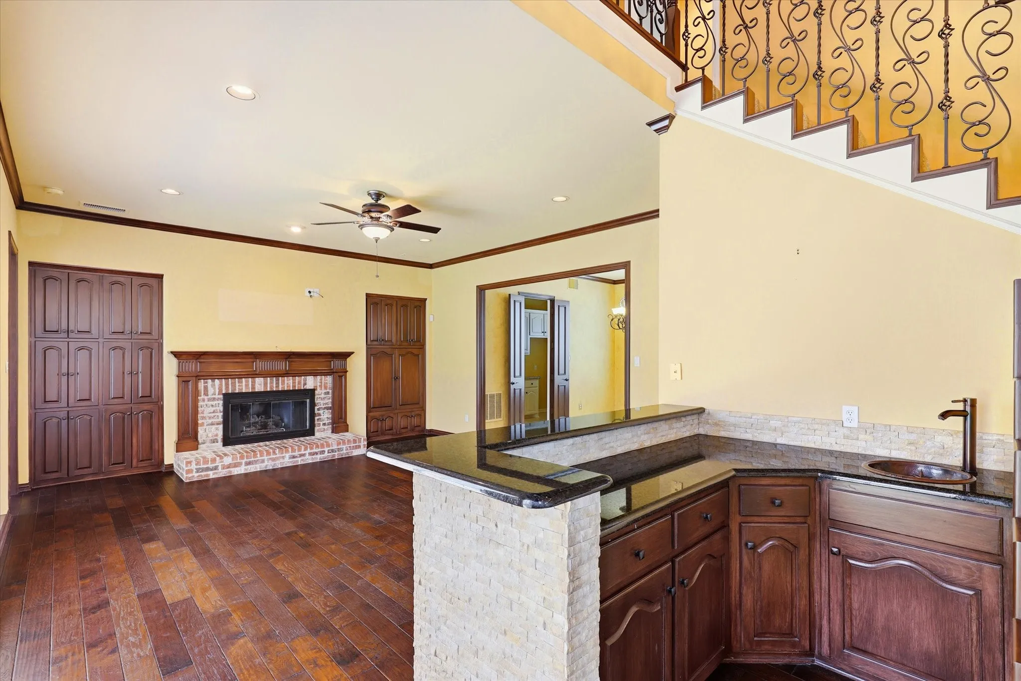 The wet bar adds a convenient entertaining space between the main living areas, with generous cabinetry, countertop space and room for serving guests.