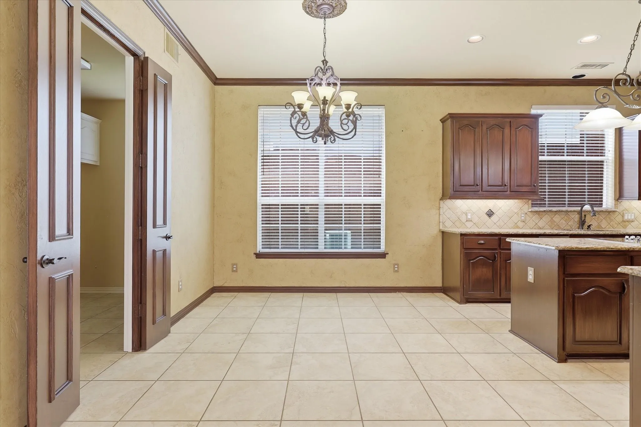 The breakfast area offers plenty of room for casual dining and overlooks the sideyard.