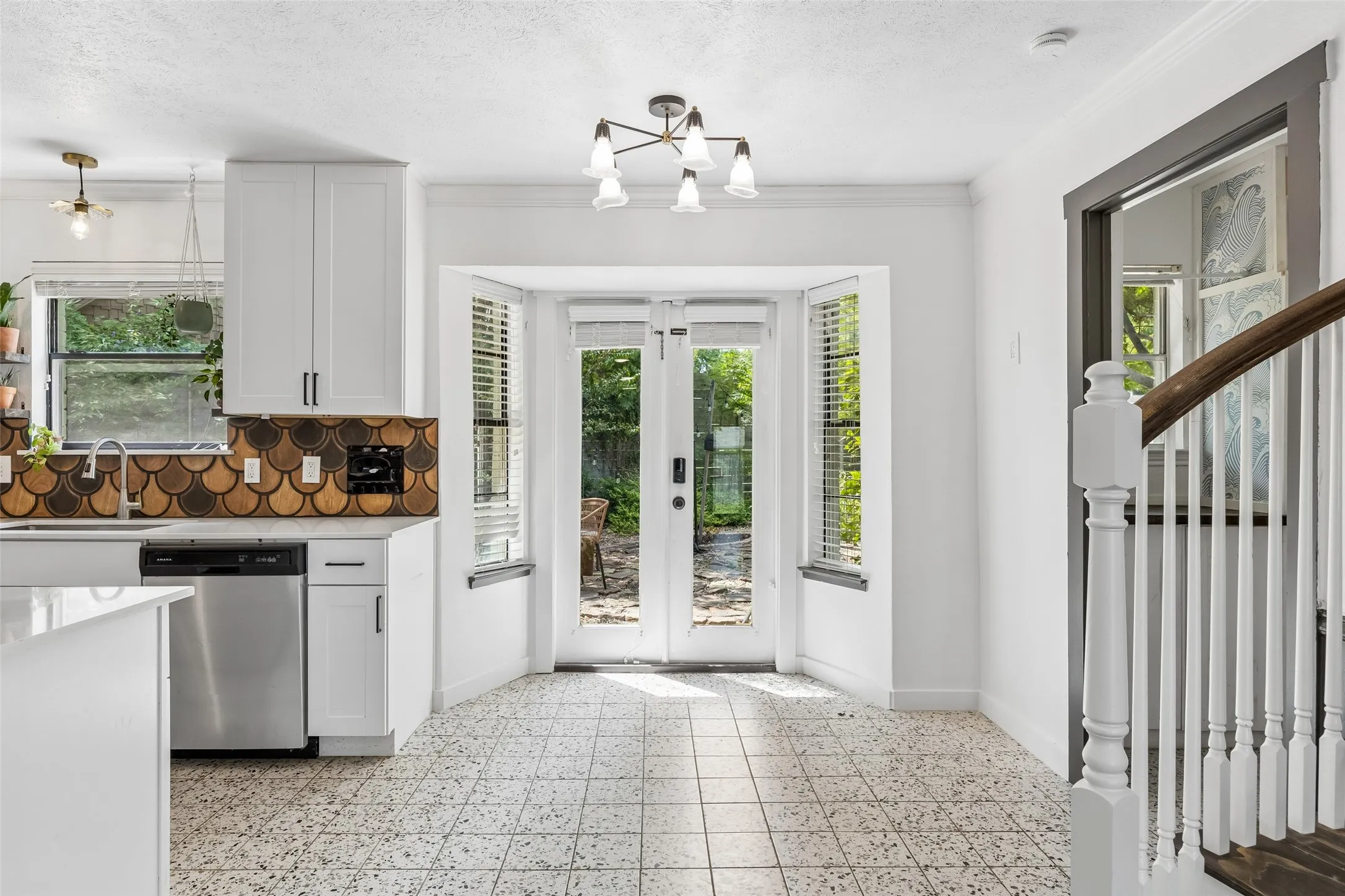 Terrazzo tile floors in the kitchen. Breakfast area leads to the entrance to the gardens