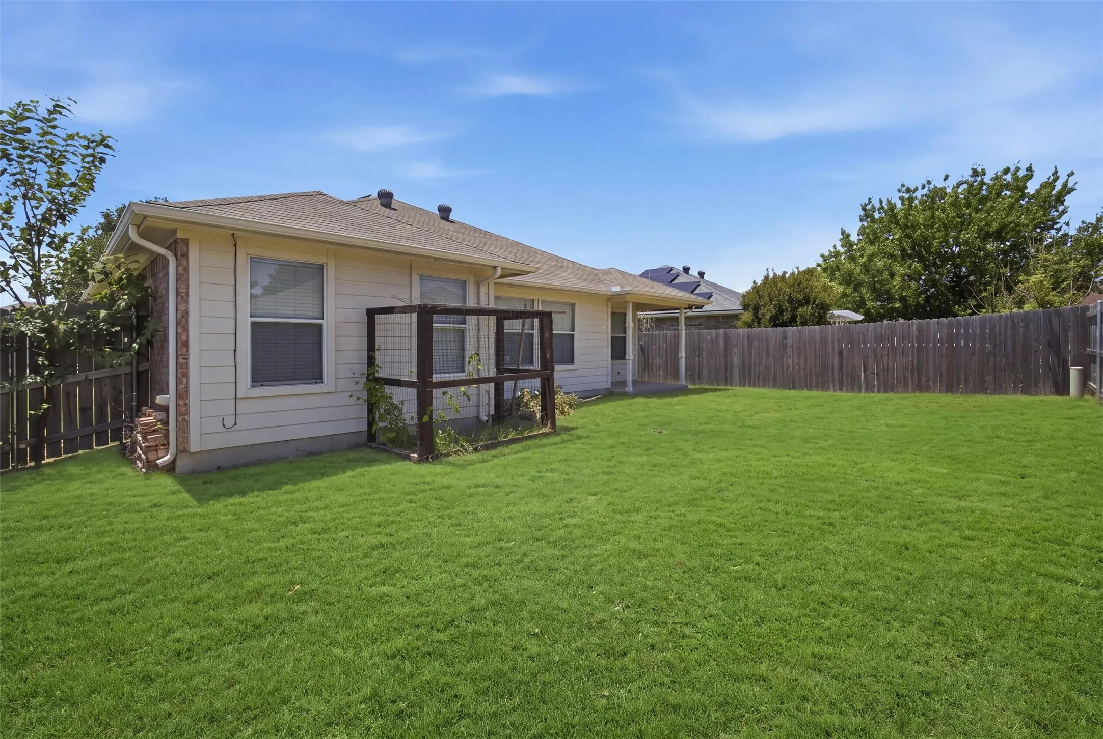 Expansive rear yard featuring a large grass lawn