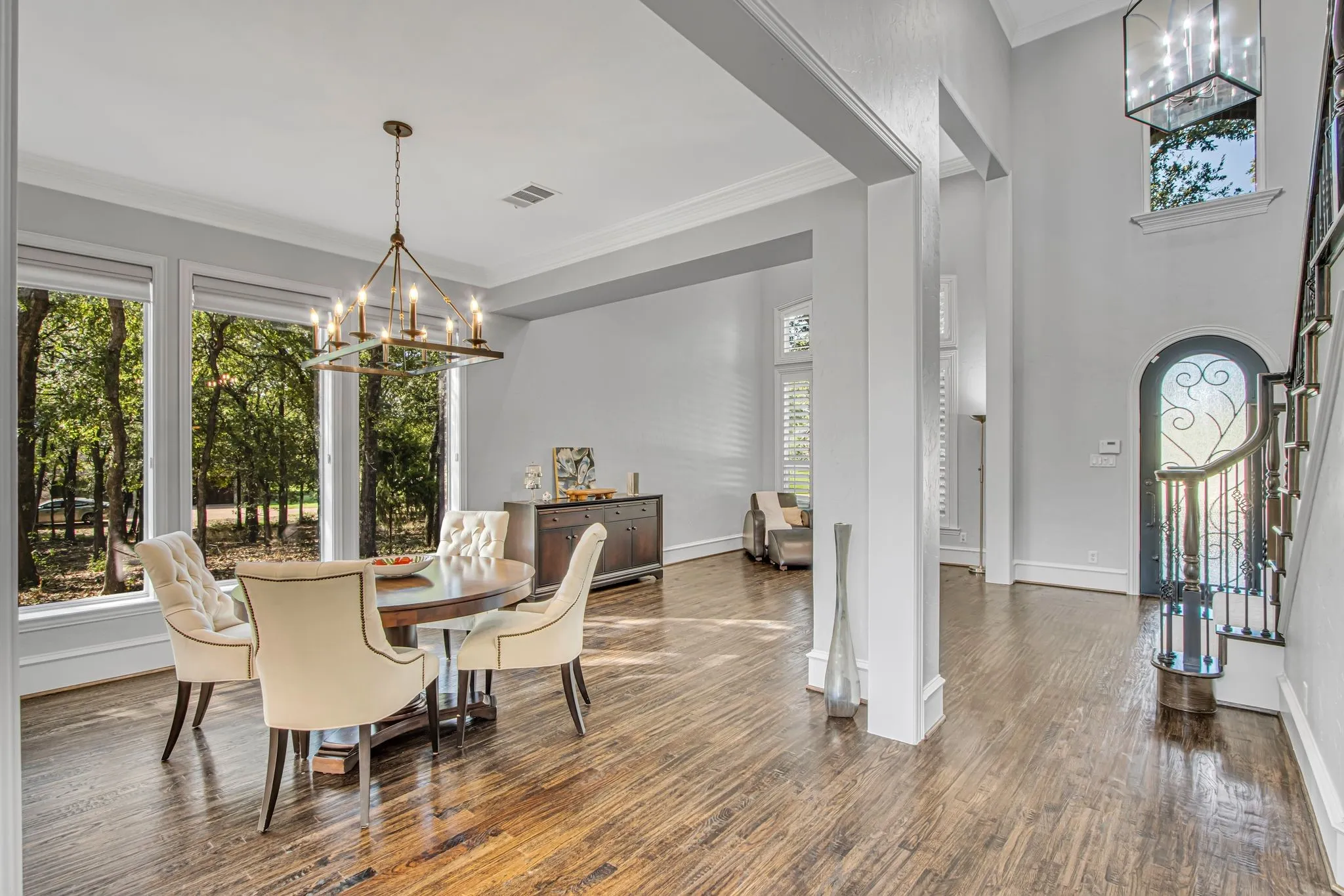 Formal dining room featuring windows overlooking the natural wooded forest area.