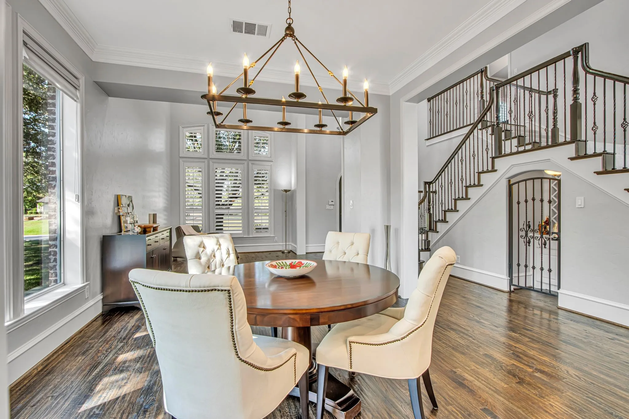 Formal dining area off the foyer with wine grotto under the dual sided staircase.