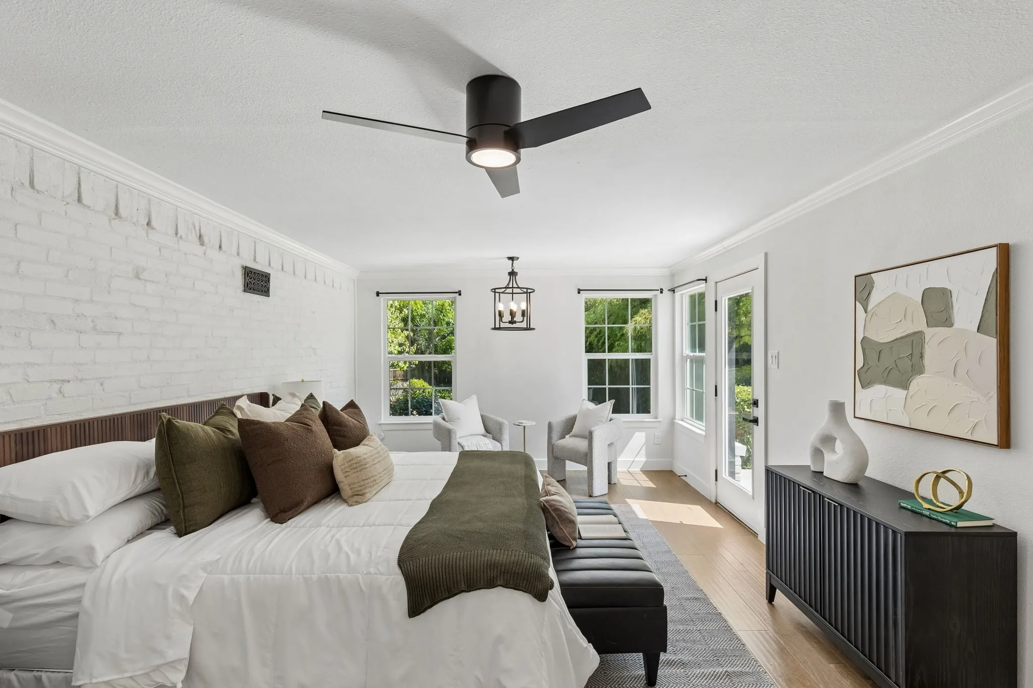White-painted brick accent wall with crown molding