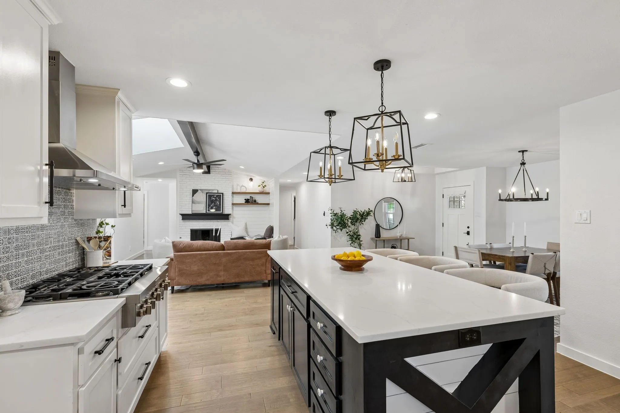 Open-concept kitchen with a substantial island, recessed lighting, and wood-finish flooring