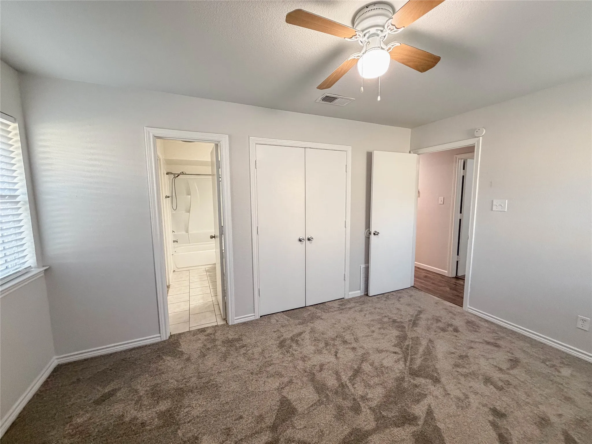 Ceiling fan with wood-finish blades and integrated lighting