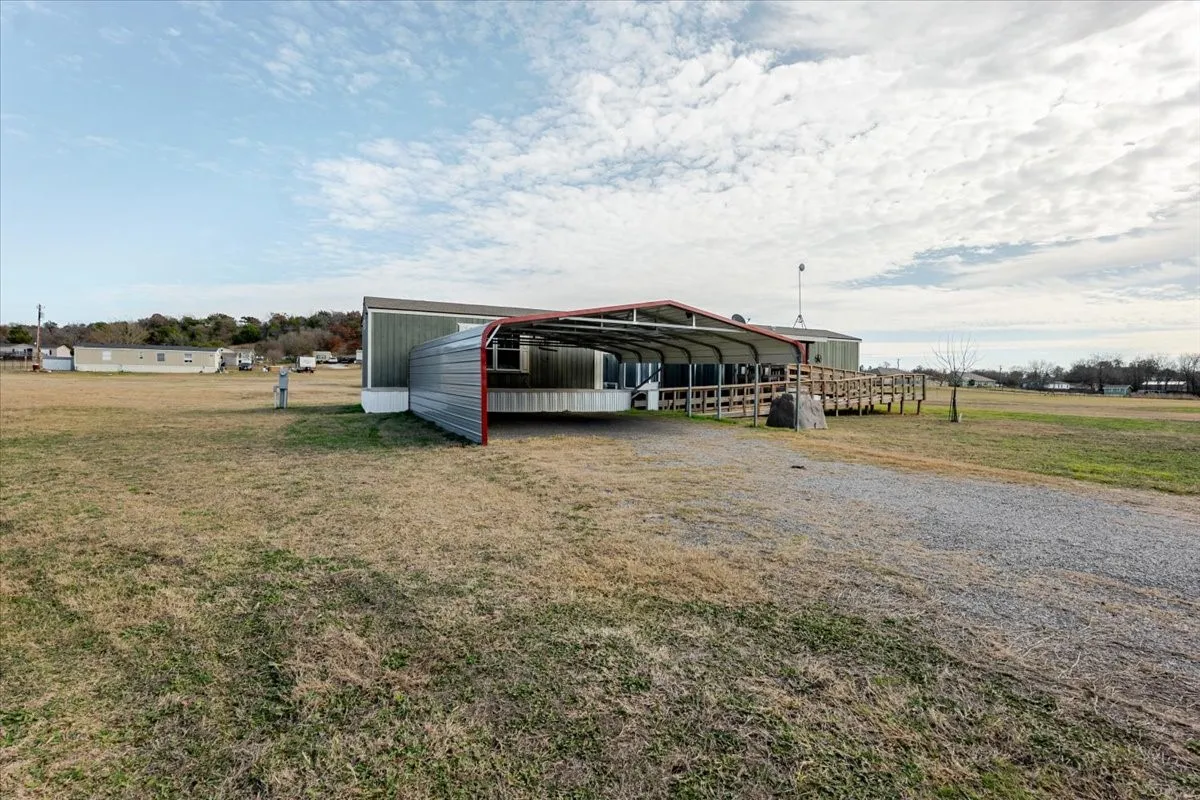 Carport has two parking spaces. There is a ramp leading to deck, Perfect for  moving furniture in.