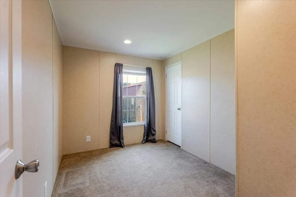 3rd bedroom features carpet  and walk in closet.