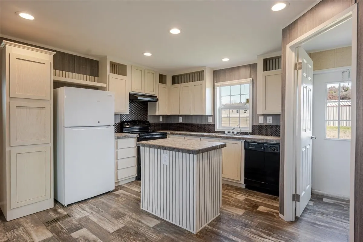Kitchen featuring wood-finish flooring, recessed lighting, and a center island with a stone-look countertop.  Refrigerator does not convey.