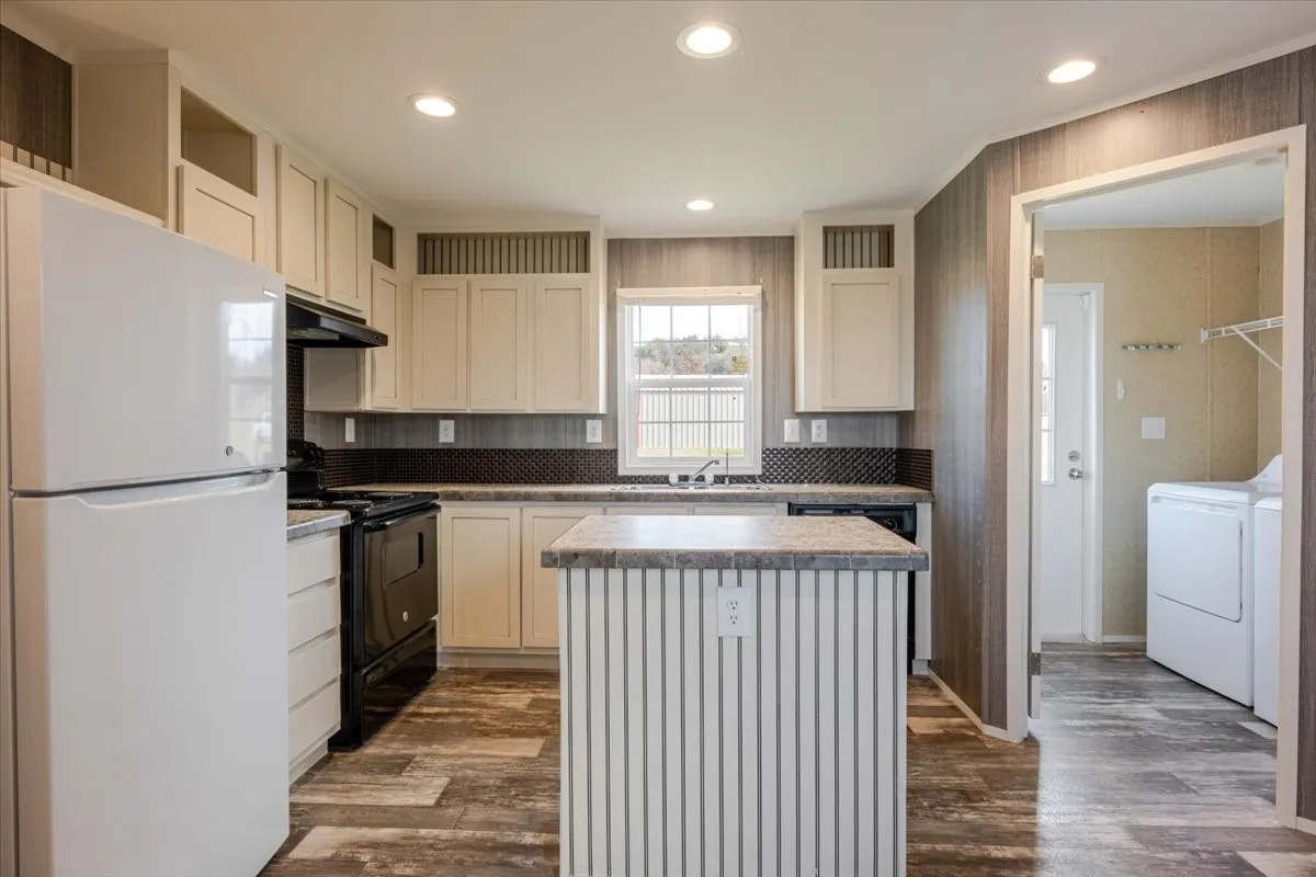 Kitchen featuring wood-finish flooring, recessed lighting, cream-colored cabinetry, a dark tile backsplash, and a central island with a granite-look countertop