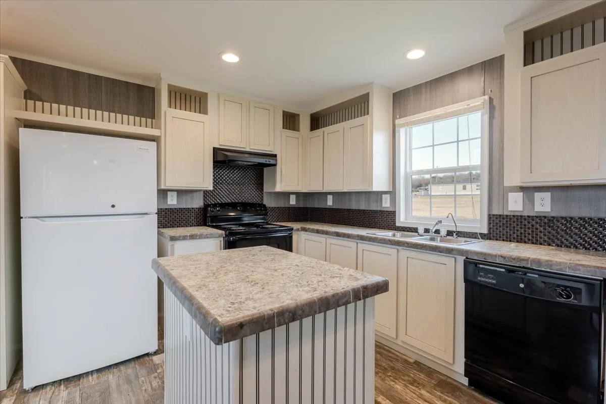 Open-concept kitchen featuring an island with a laminate countertop, light cabinetry, white refrigerator, black range, and black dishwasher