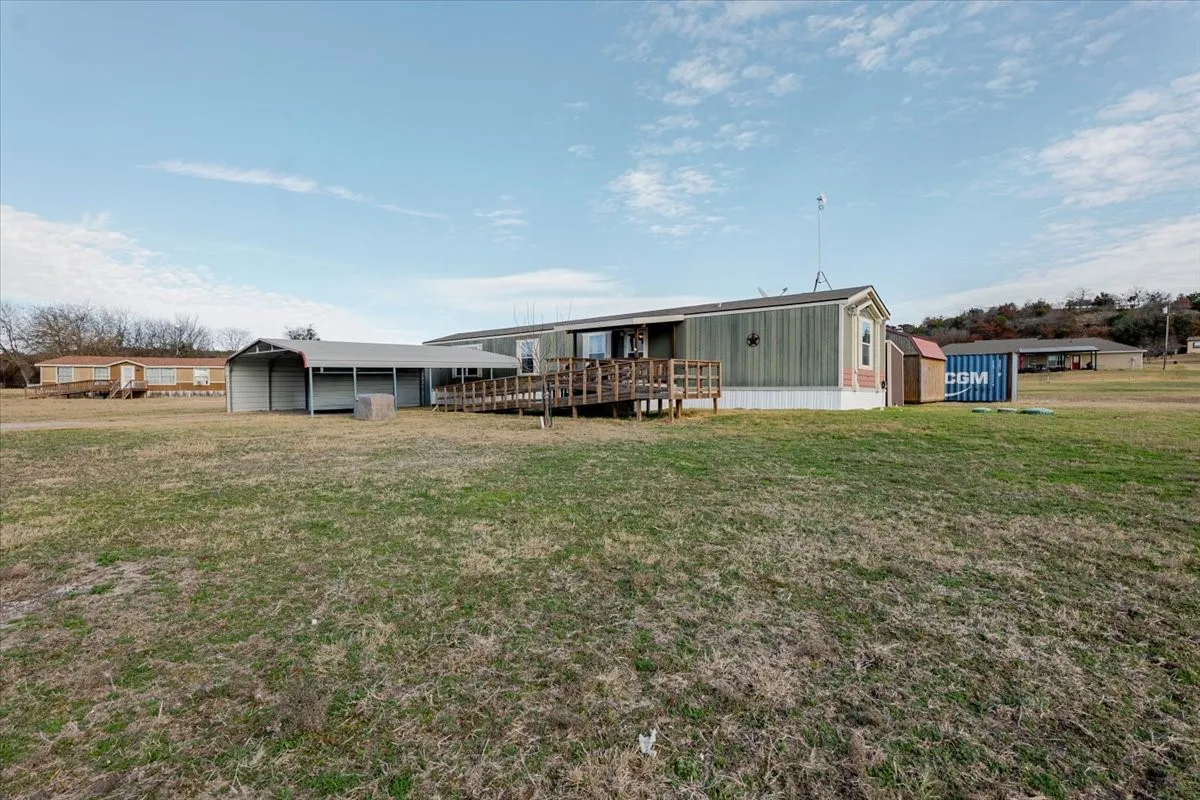 Front view including ramp and carport.