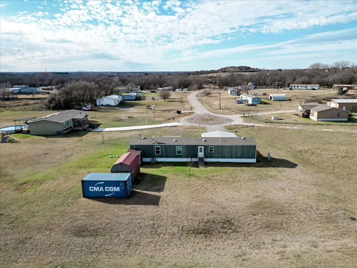 Rear view of mobile home and storage units.