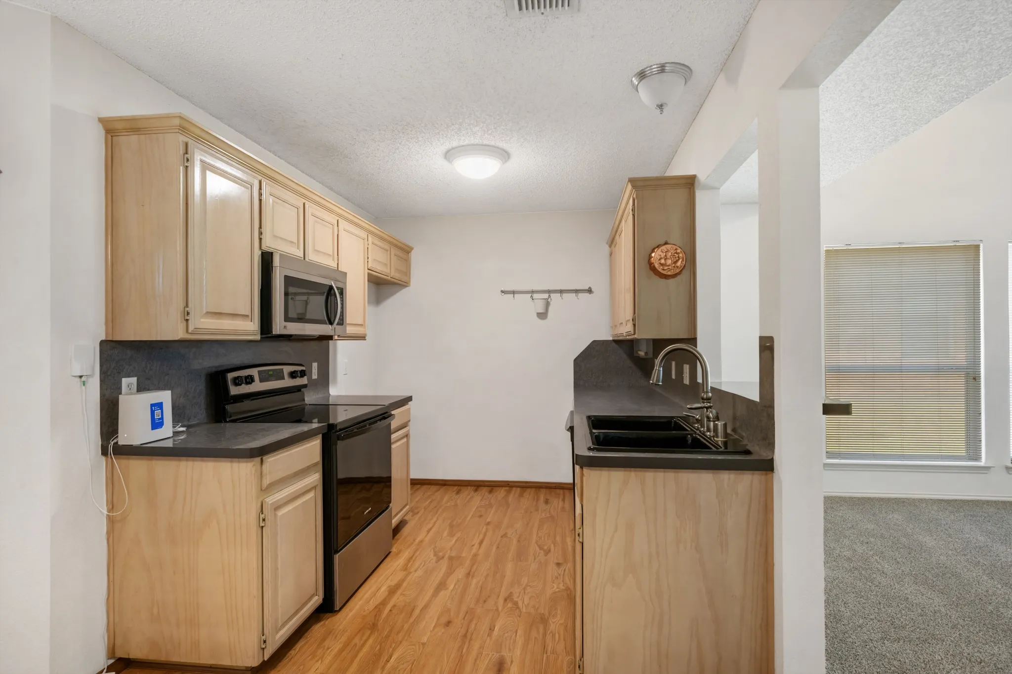 Kitchen has an opening into the living room.