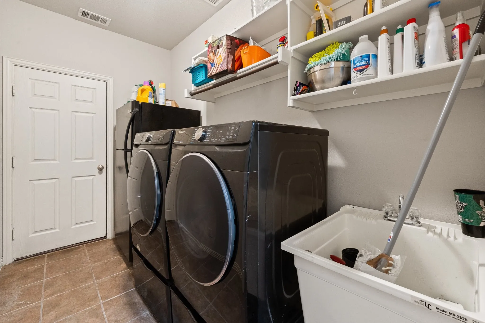 Laundry Room is Downstairs, located near Primary, and offers space for 2nd Fridge. Great Utility SINK & built-in shelving. Washer/Dryer DO NOT Convey. White paneled door OPENS to 3-Car Garage!