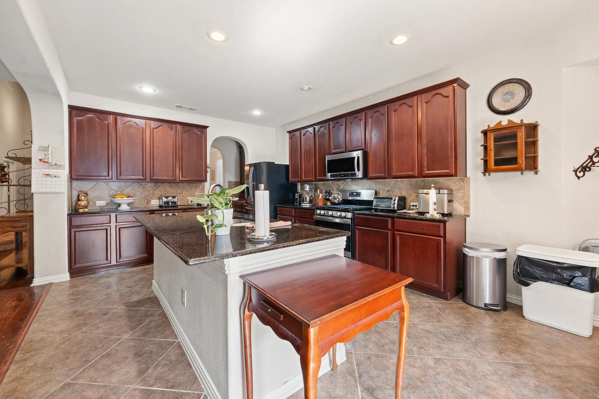 Large Kitchen Island, granite countertops, GAS Range, recessed lighting, and rich wood-finish cabinetry - OPENS to Butler's Pantry by Fridge.
