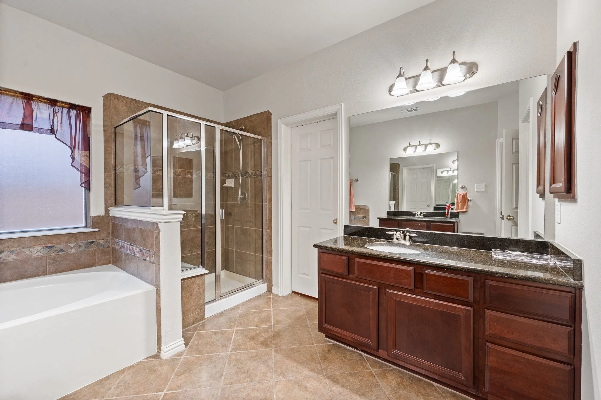 Primary Ensuite BATH features Soaking Tub, Separate Shower, DUAL Vanities, Dual SINKS (see the 2nd Vanity & Sink in the mirror across from the Vanity shown).