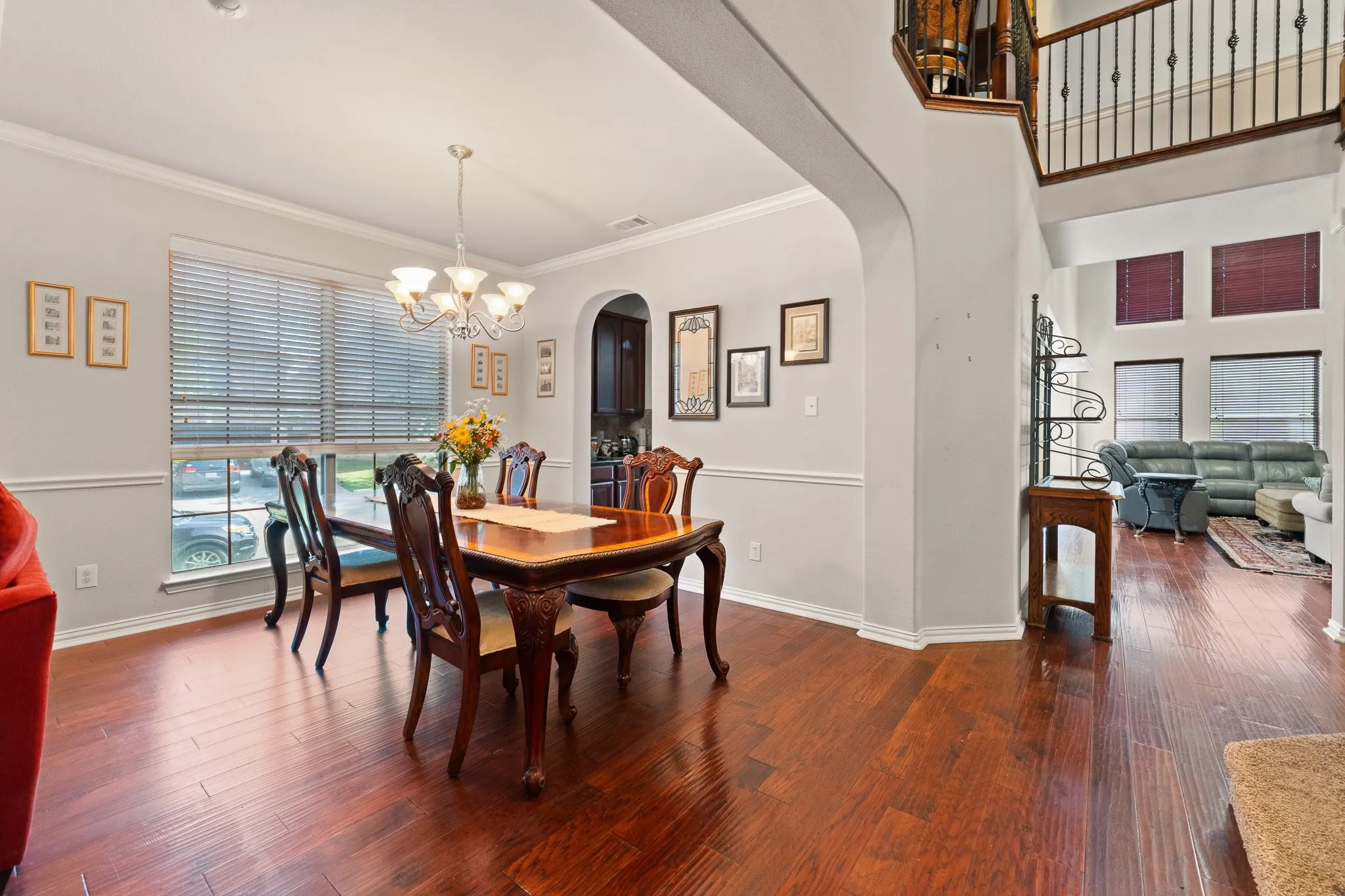 Formal Dining features Wood Flooring, Crown Molding, Chair Rail detailing, and OPENS to Butler's Pantry with Family Room and Kitchen around the corner...