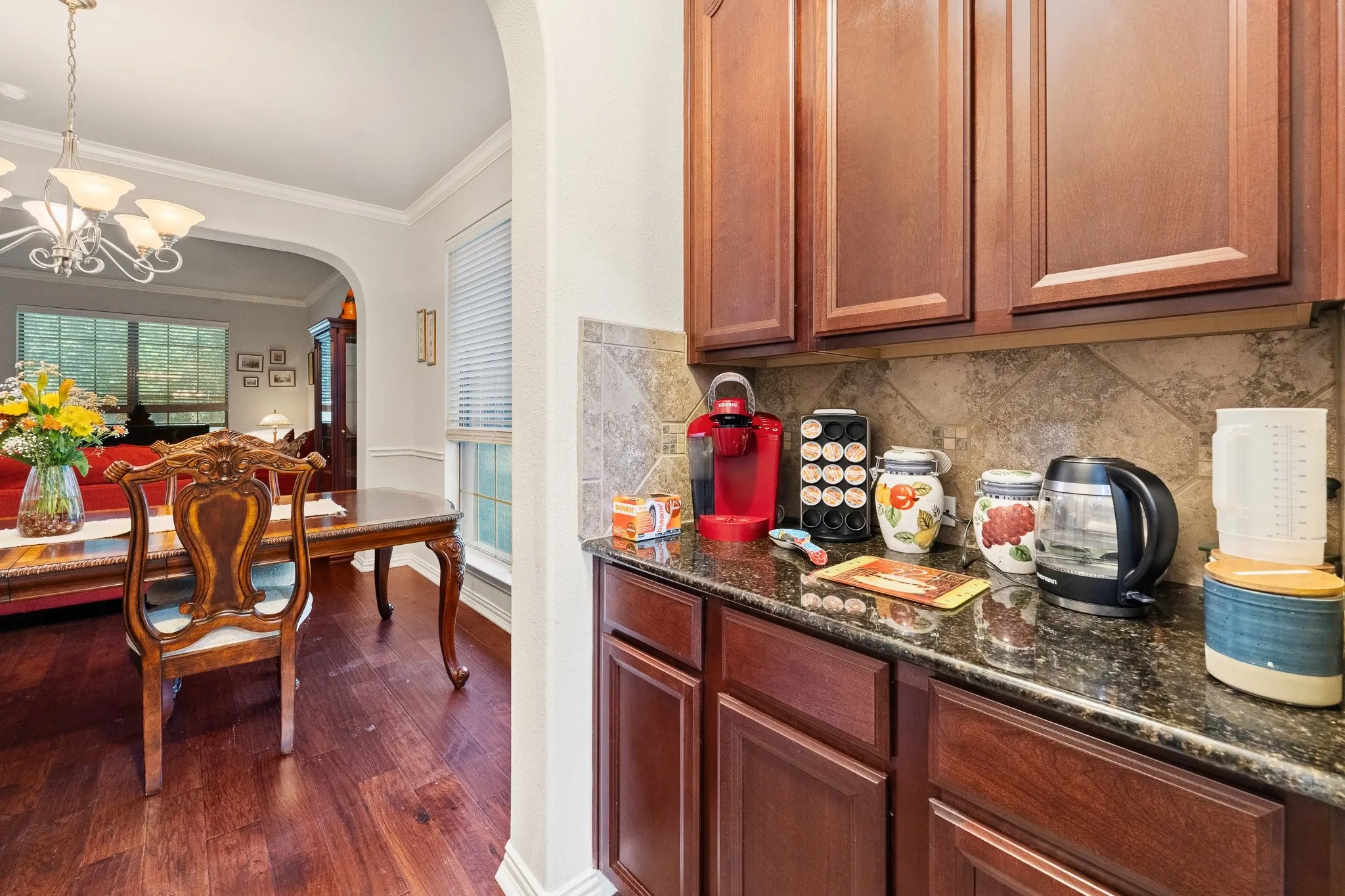 Convenient Butler's Pantry between Dining and Kitchen features Granite Countertops, built-in Cabinets, and a LARGE Walk-In Kitchen Pantry (not shown).