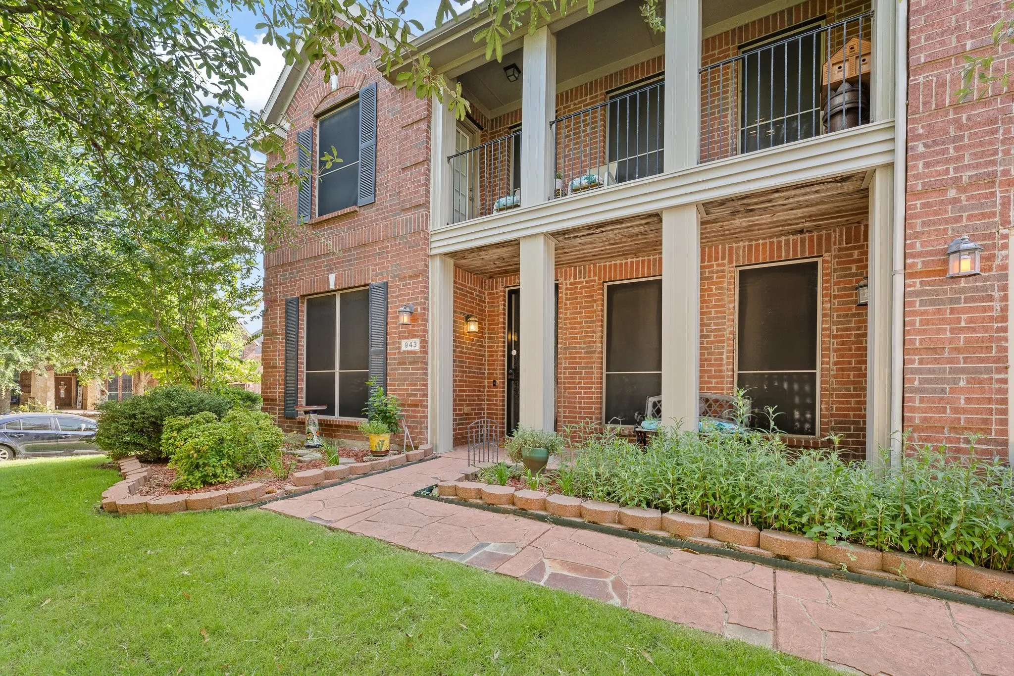 Relax on the Covered Front Porch and 2nd Story BALCONY!!  Front yard TREES offer lots of Shade.