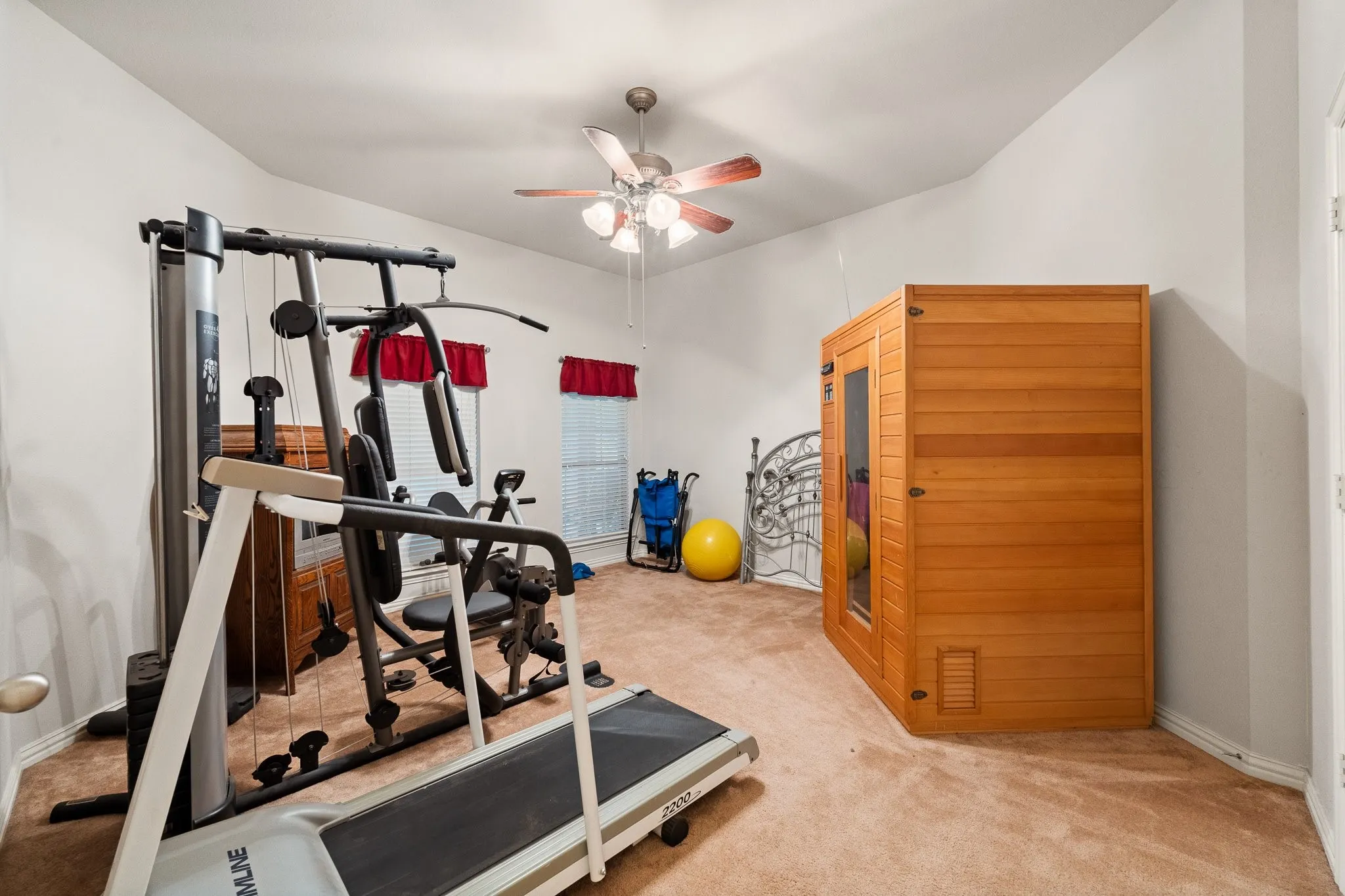 Upstairs Bedroom 6: Carpeted flooring and ceiling fan (Exercise Equipment & Sauna DOES NOT Convey).